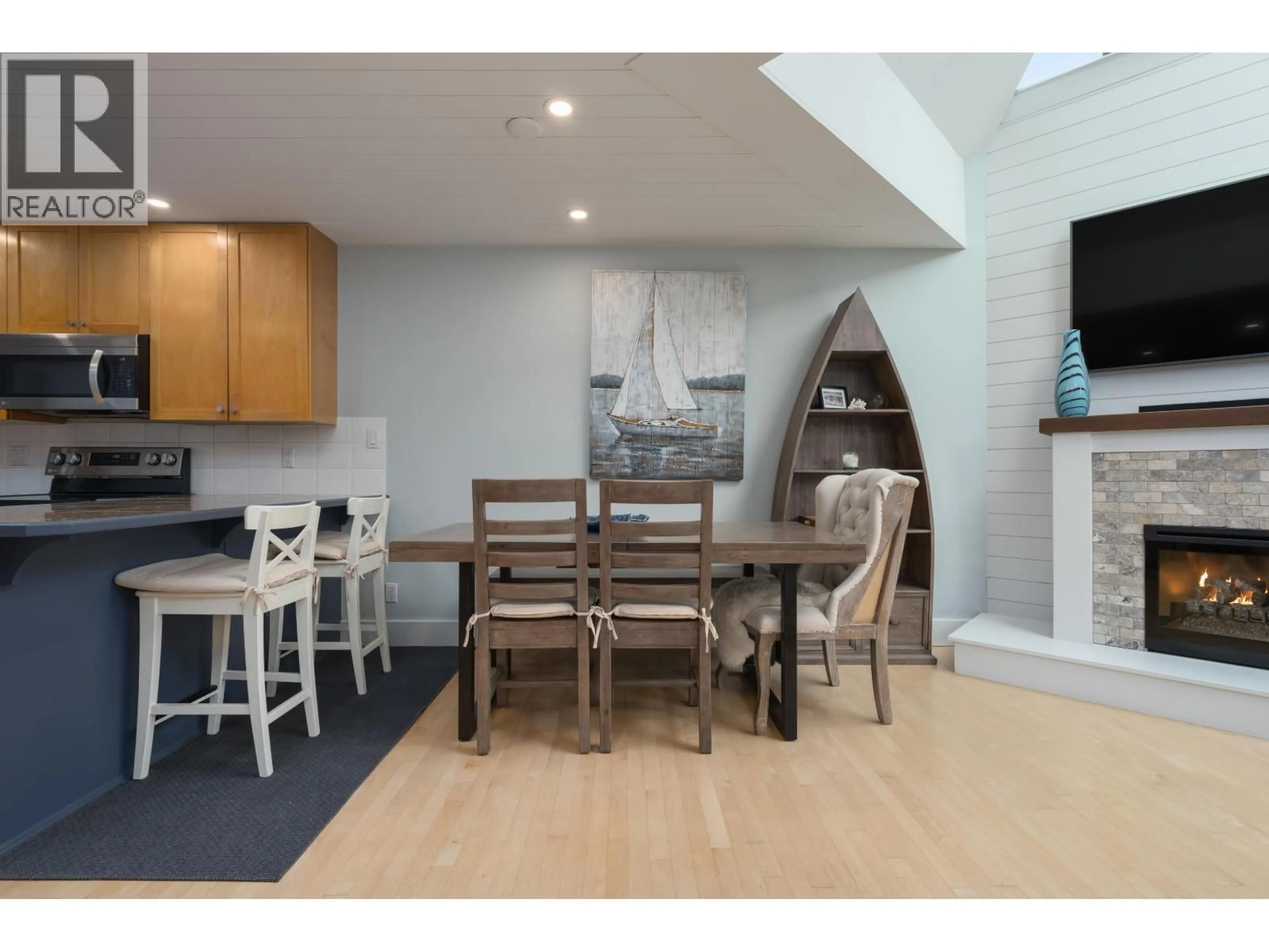 Open concept kitchen, wood/laminate floor for 104 - 1477 FOUNTAIN WAY, Vancouver British Columbia V6H3W9