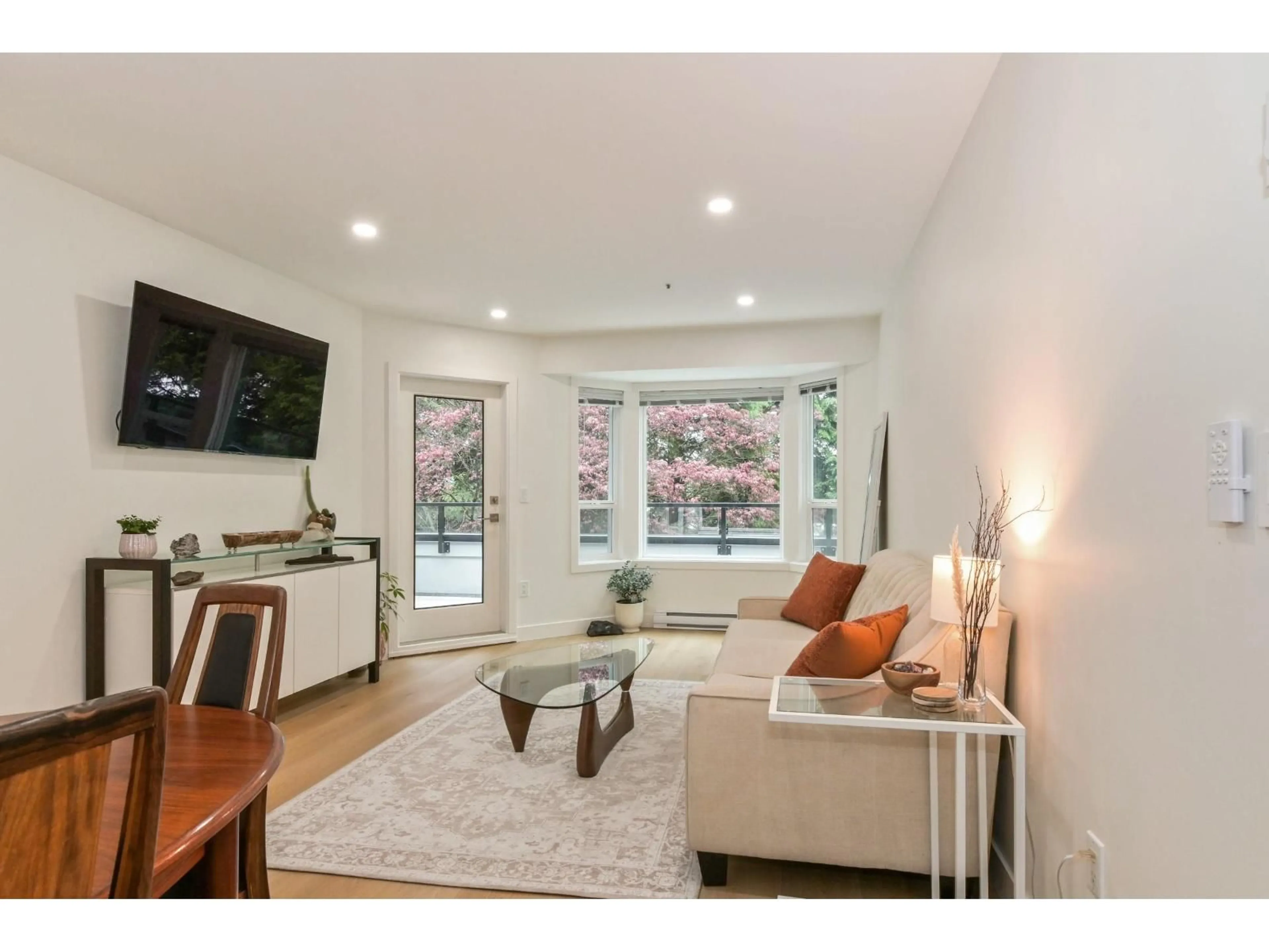 Living room with furniture, wood/laminate floor for 203 - 2700 MCCALLUM ROAD, Abbotsford British Columbia V2S6X9