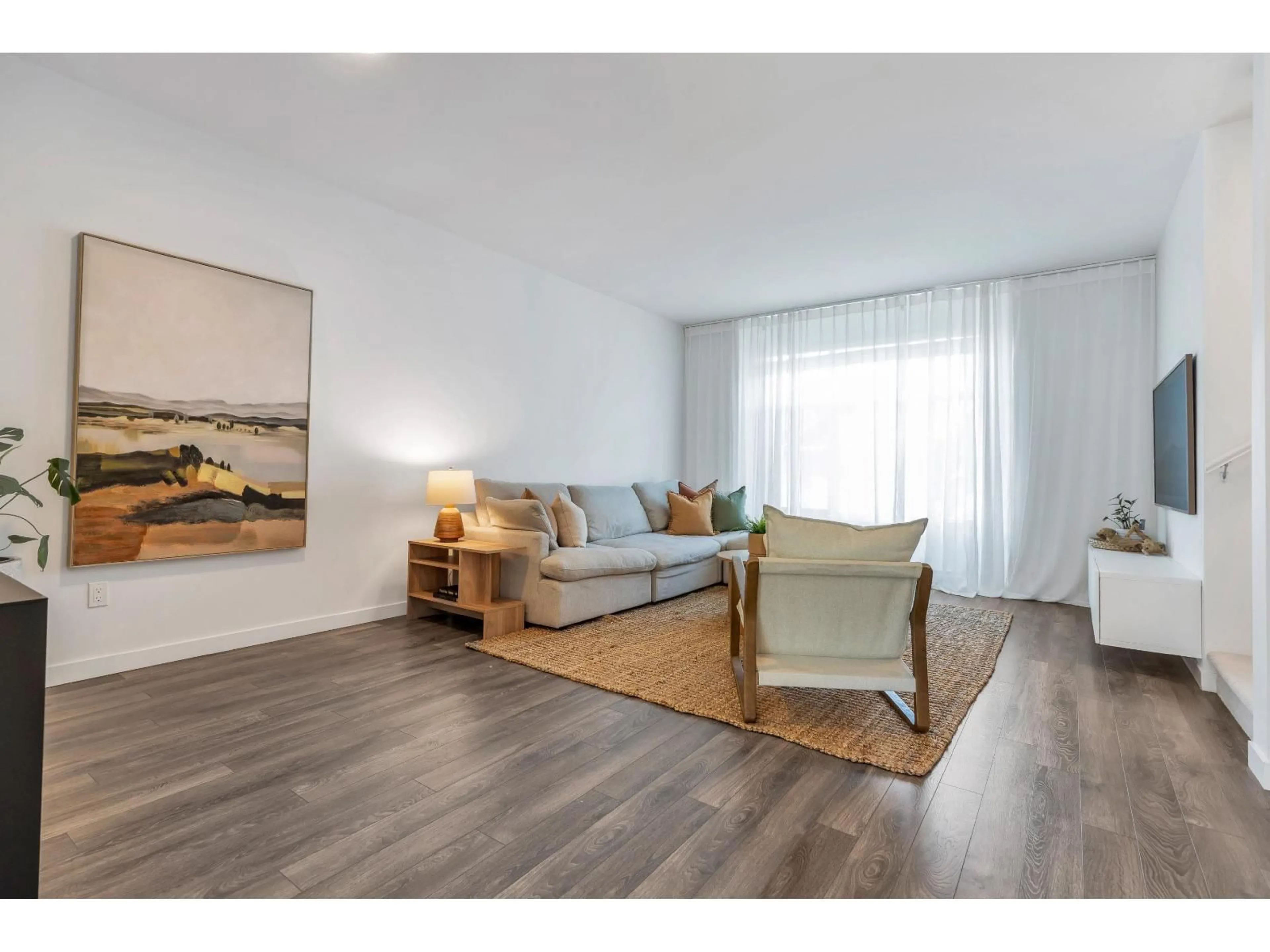 Living room with furniture, wood/laminate floor for 103 - 15268 28 AVENUE, Surrey British Columbia V4P0E8