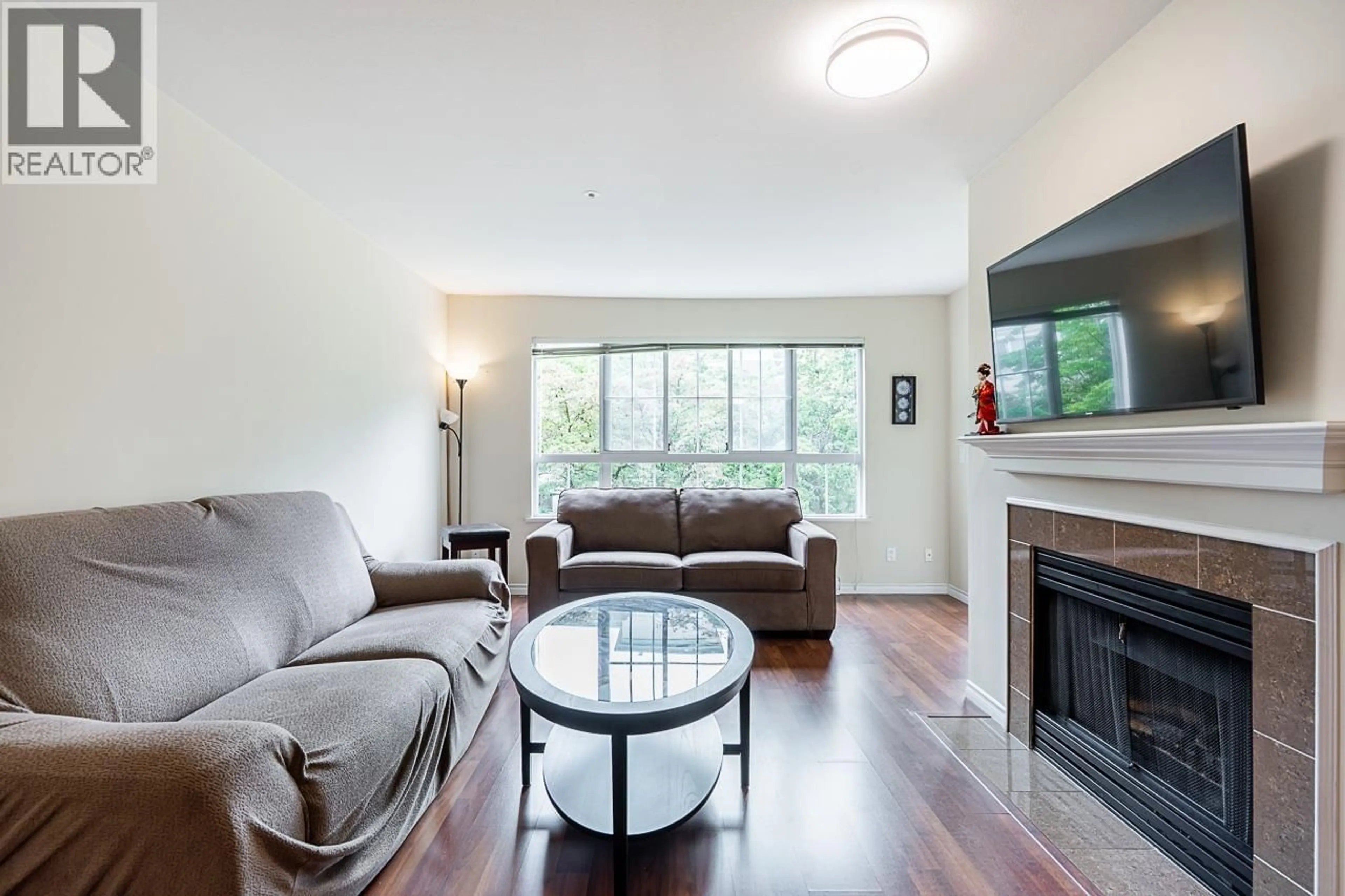 Living room with furniture, wood/laminate floor for 227 - 2980 PRINCESS CRESCENT, Coquitlam British Columbia V3B7R4