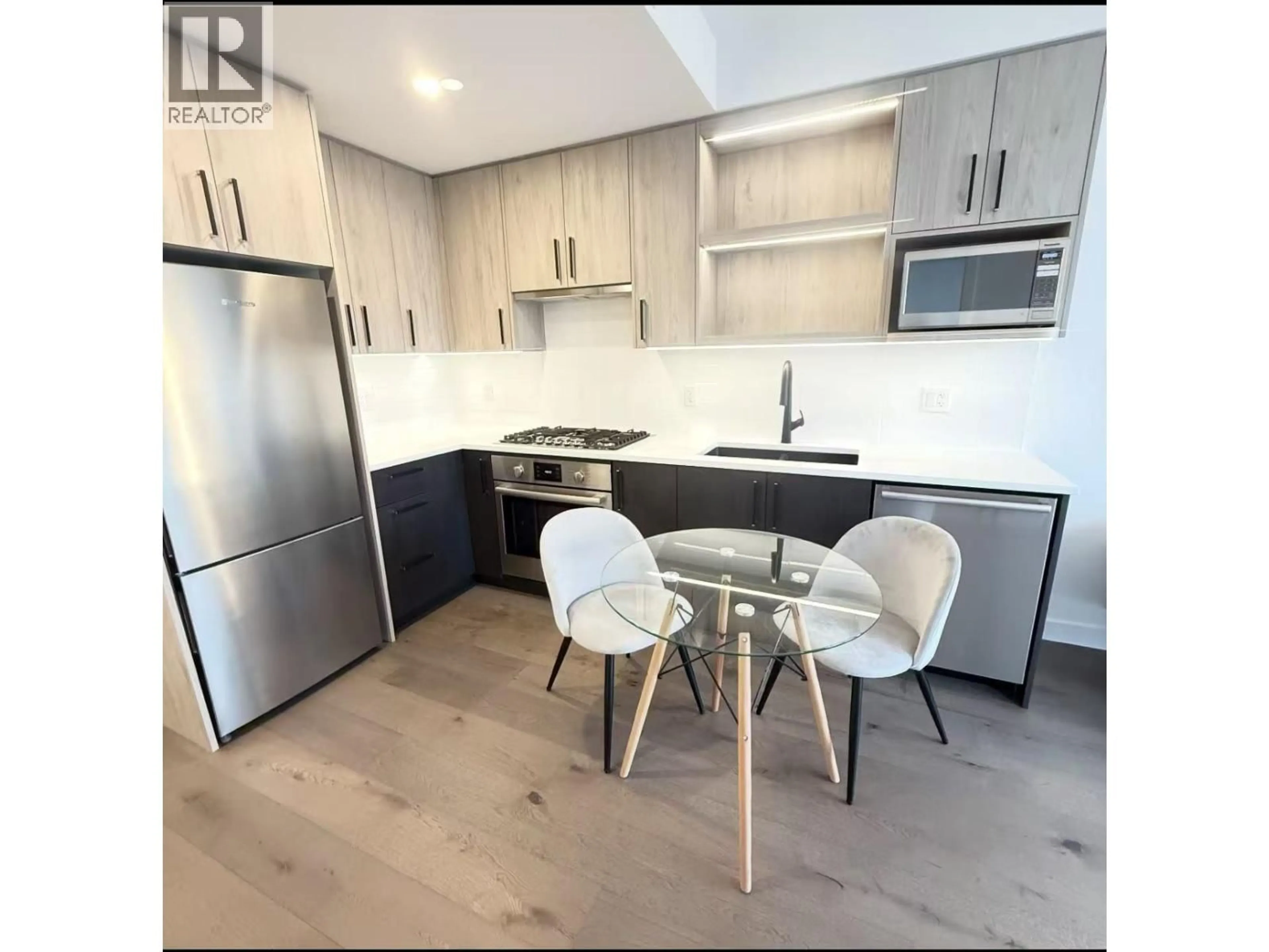 Open concept kitchen, wood/laminate floor for 313 - 6859 CAMBIE STREET, Vancouver British Columbia V6P3H1