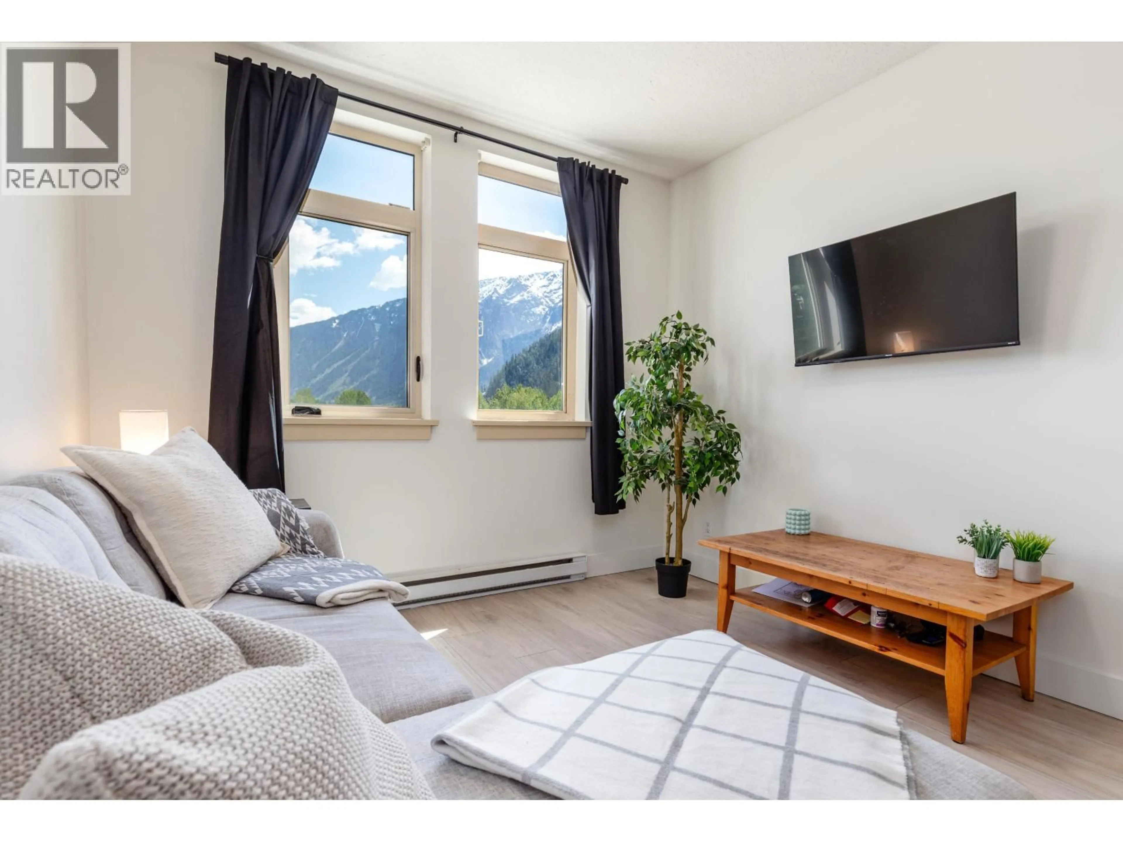 Living room with furniture, wood/laminate floor for 309 - 7330 ARBUTUS STREET, Pemberton British Columbia V0N2L1
