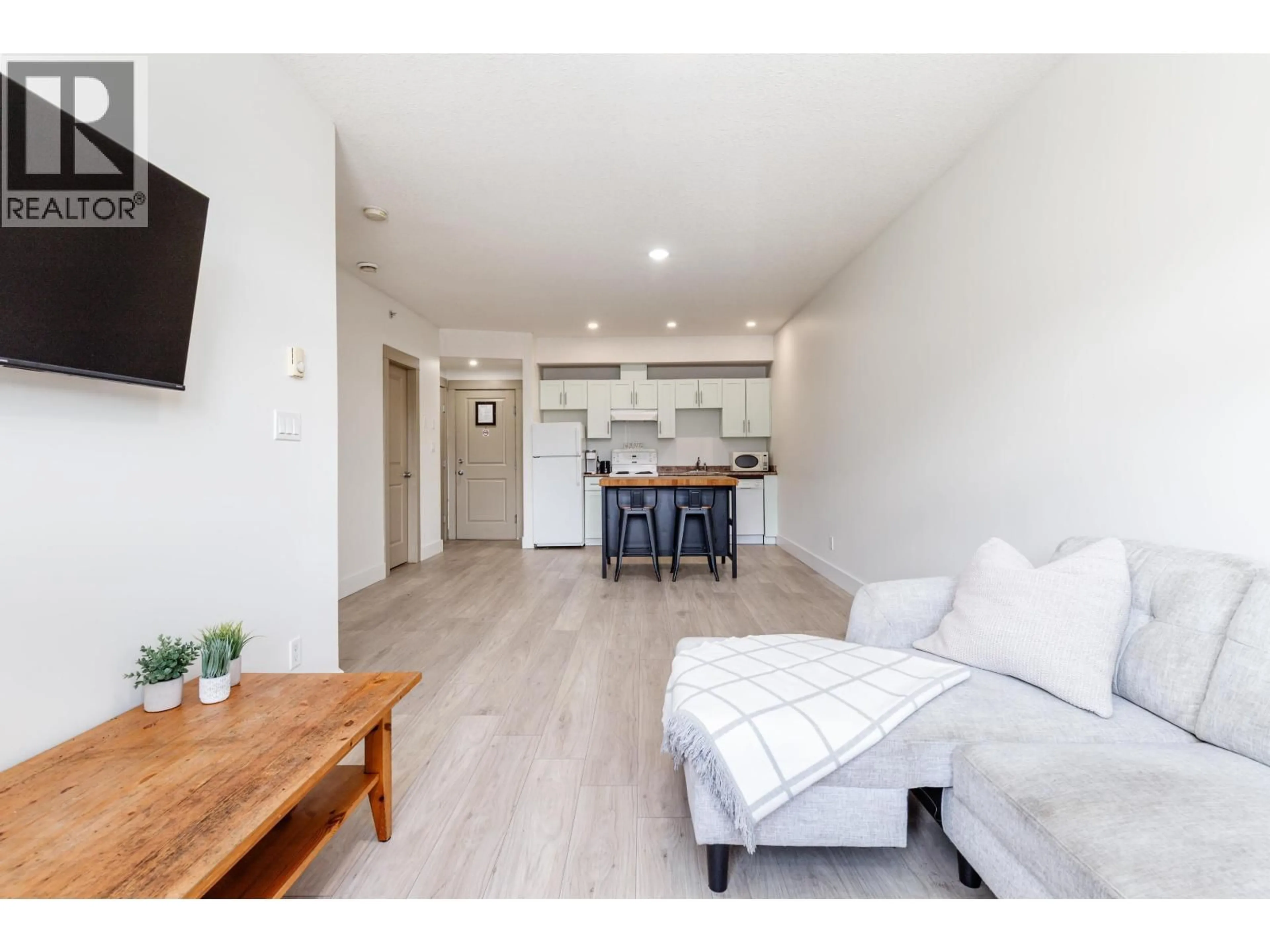 Living room with furniture, wood/laminate floor for 309 - 7330 ARBUTUS STREET, Pemberton British Columbia V0N2L1
