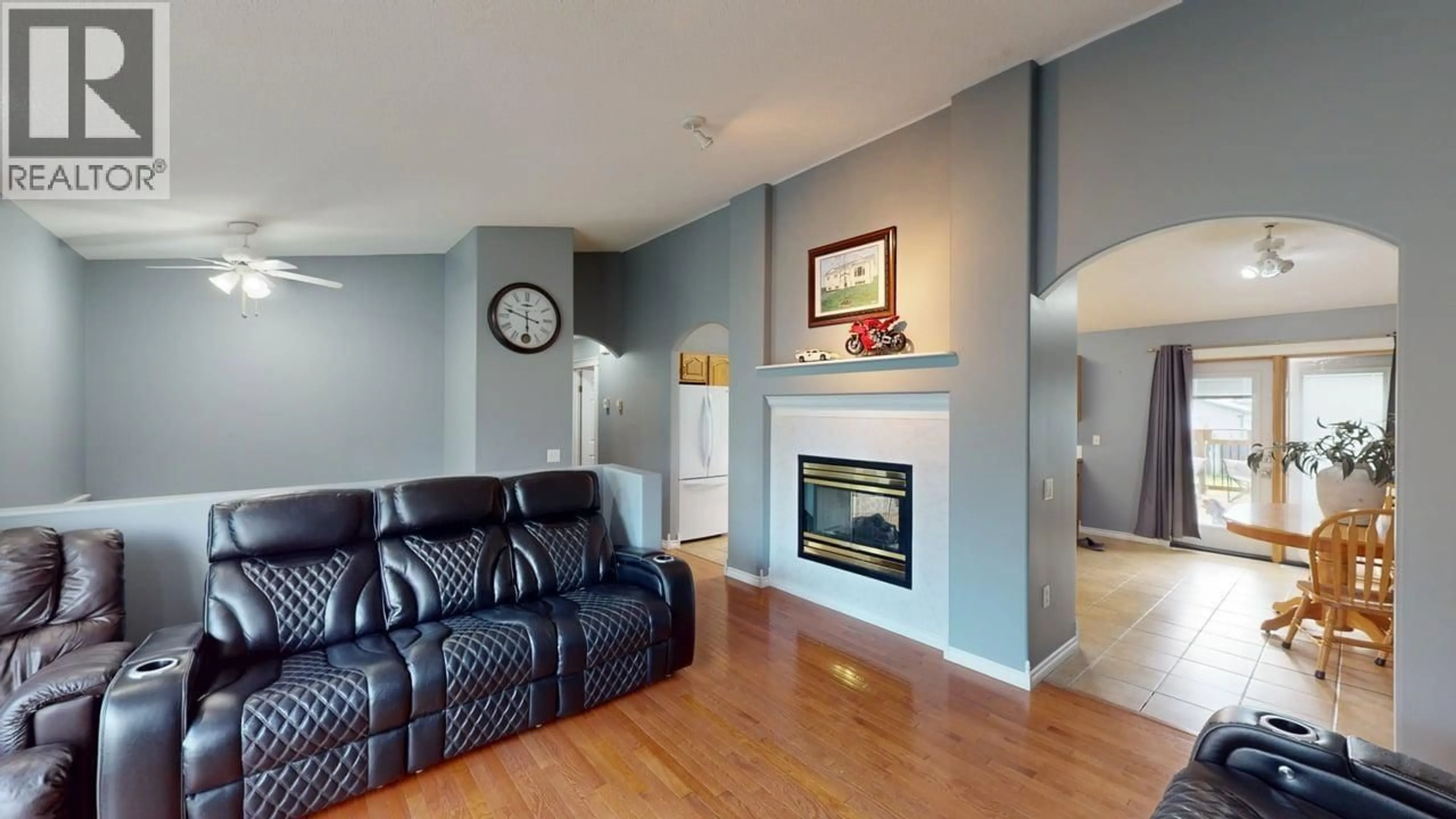 Living room with furniture, wood/laminate floor for 8604 90 STREET, Fort St. John British Columbia V1J6S9