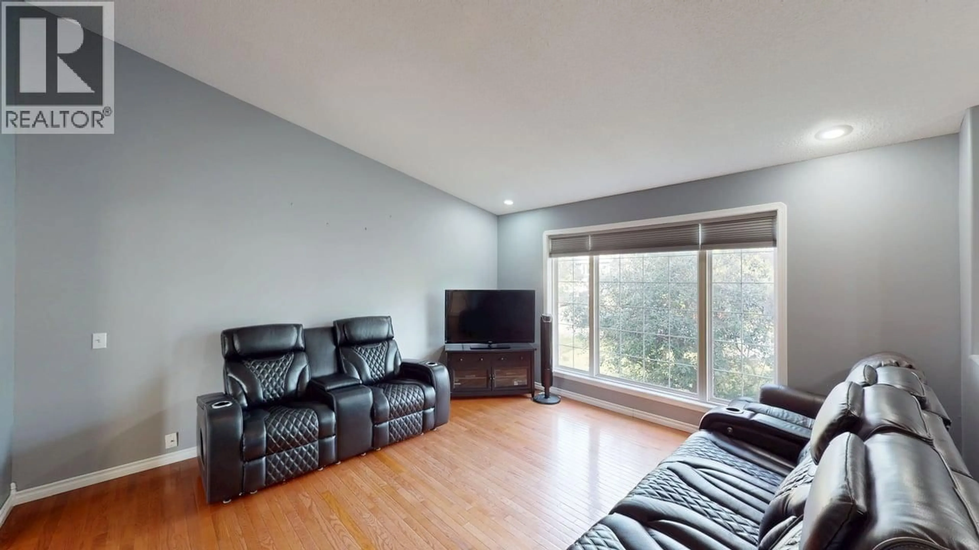 Living room with furniture, wood/laminate floor for 8604 90 STREET, Fort St. John British Columbia V1J6S9