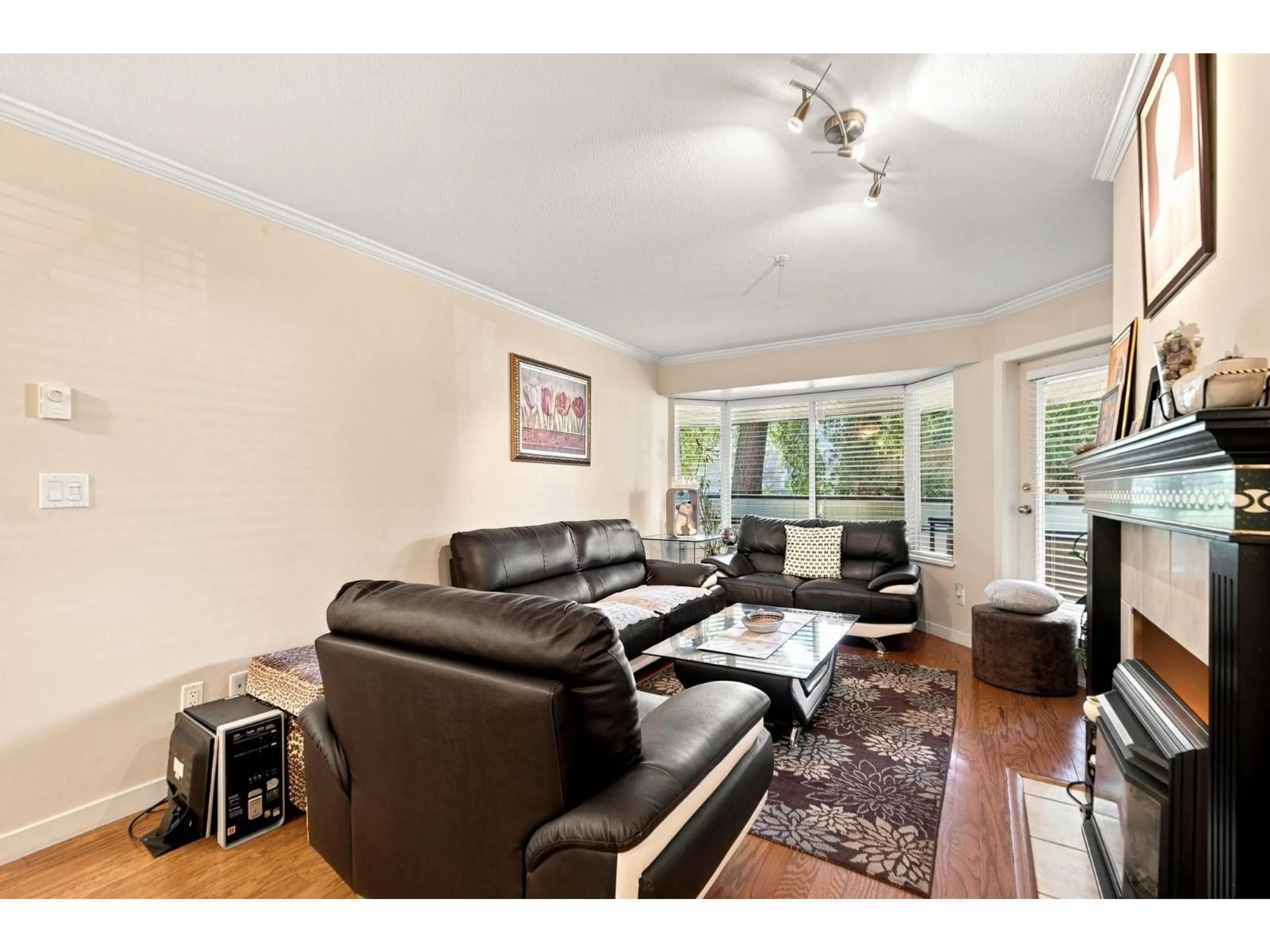 Living room with furniture, wood/laminate floor for 105 - 2958 TRETHEWEY STREET, Abbotsford British Columbia V2T6P6