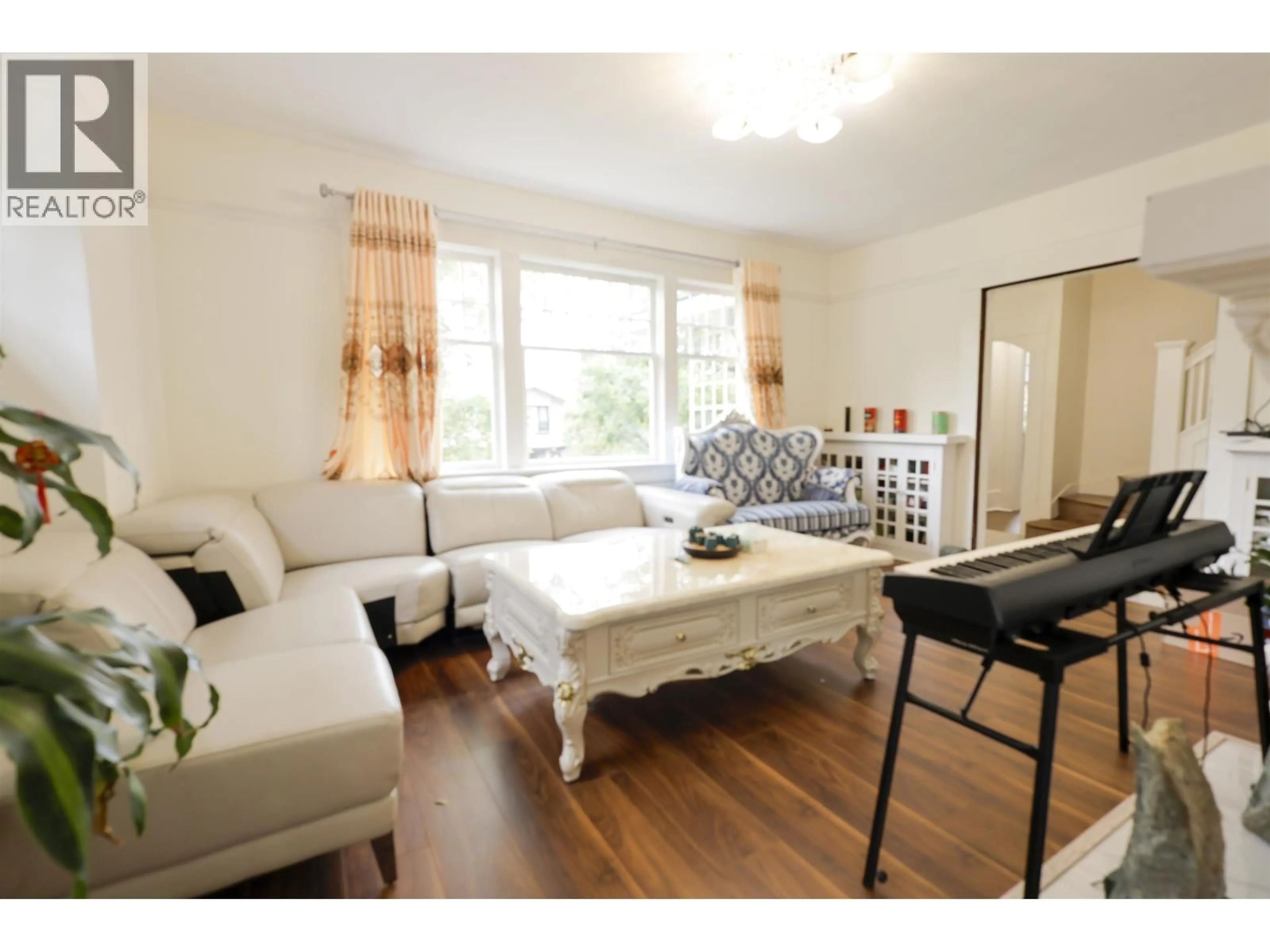 Living room with furniture, wood/laminate floor for 3874 13TH AVENUE, Vancouver British Columbia V6R2S8