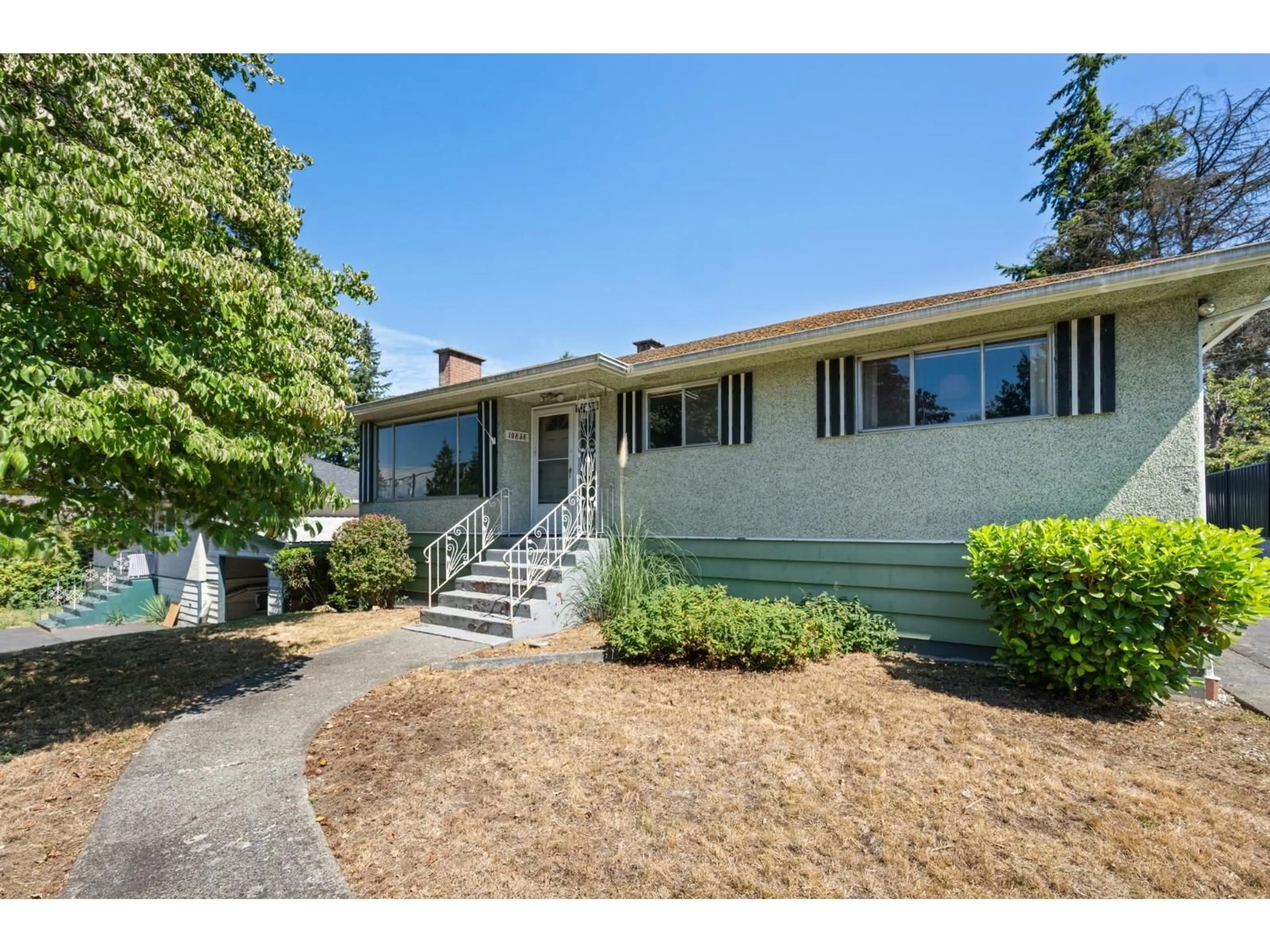 Home with vinyl exterior material, street for 10836 128 STREET, Surrey British Columbia V3T3A3