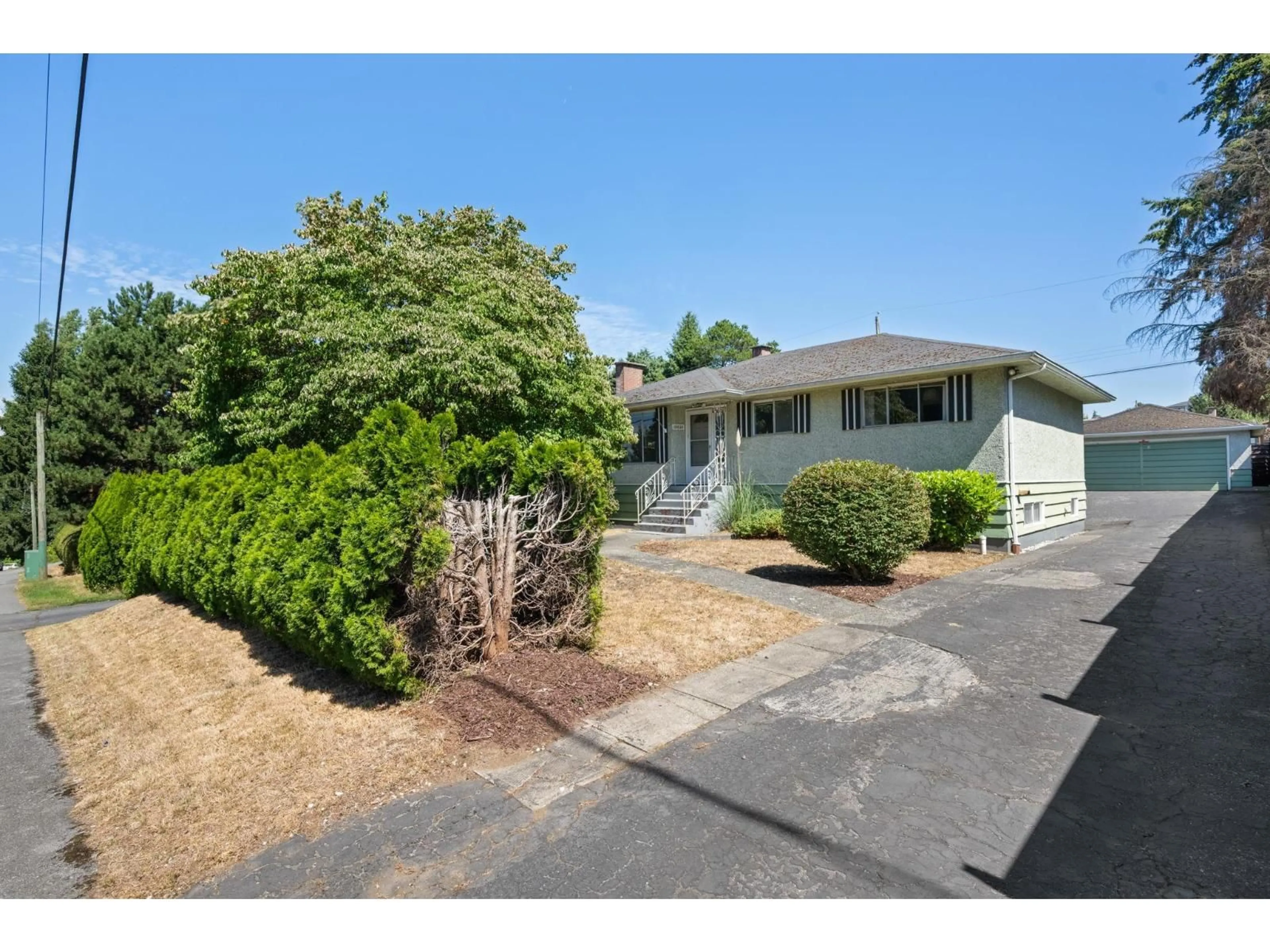 Home with vinyl exterior material, street for 10836 128 STREET, Surrey British Columbia V3T3A3