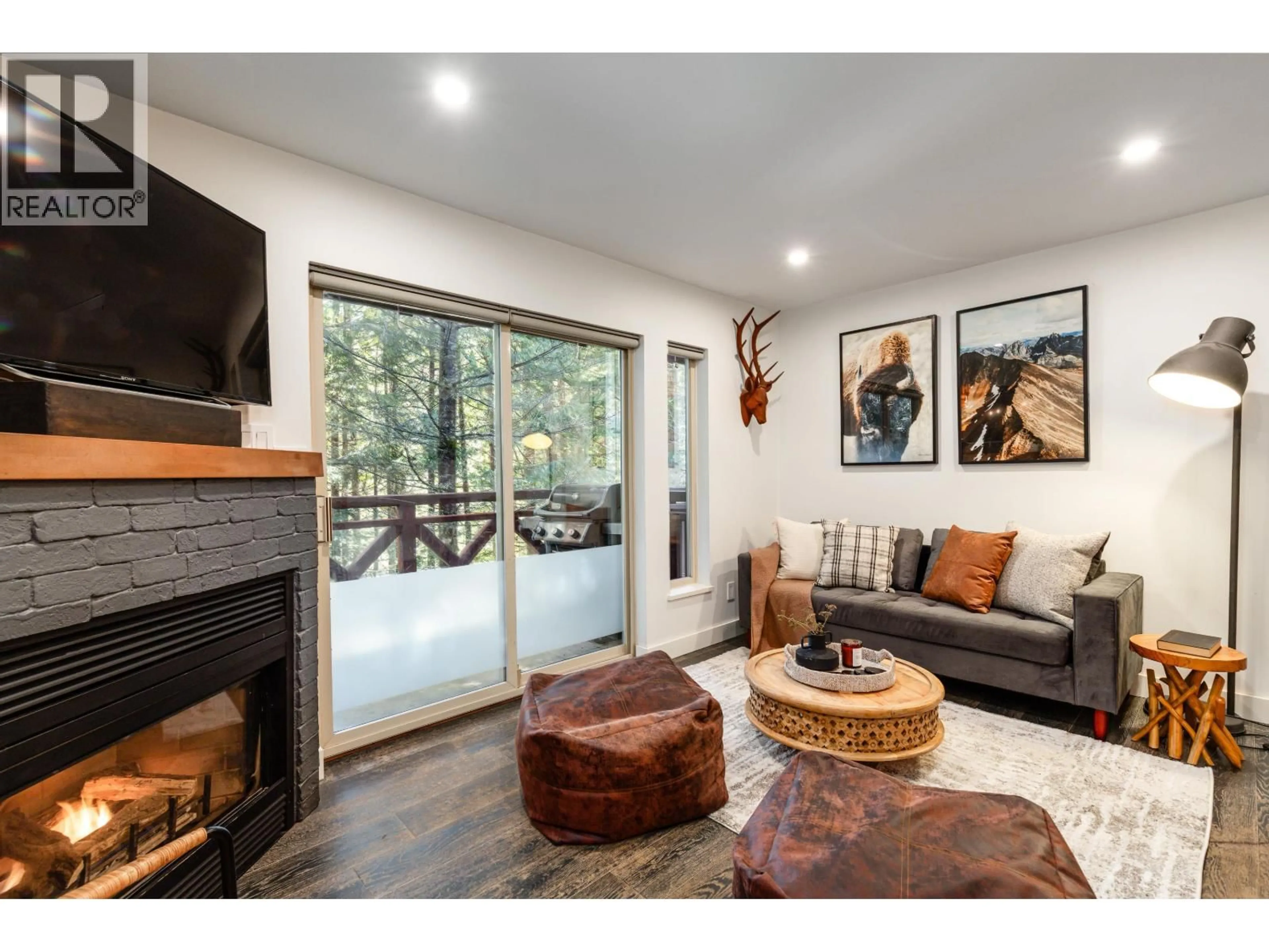 Living room with furniture, wood/laminate floor for 113 - 3070 HILLCREST DRIVE, Whistler British Columbia V8E0V1