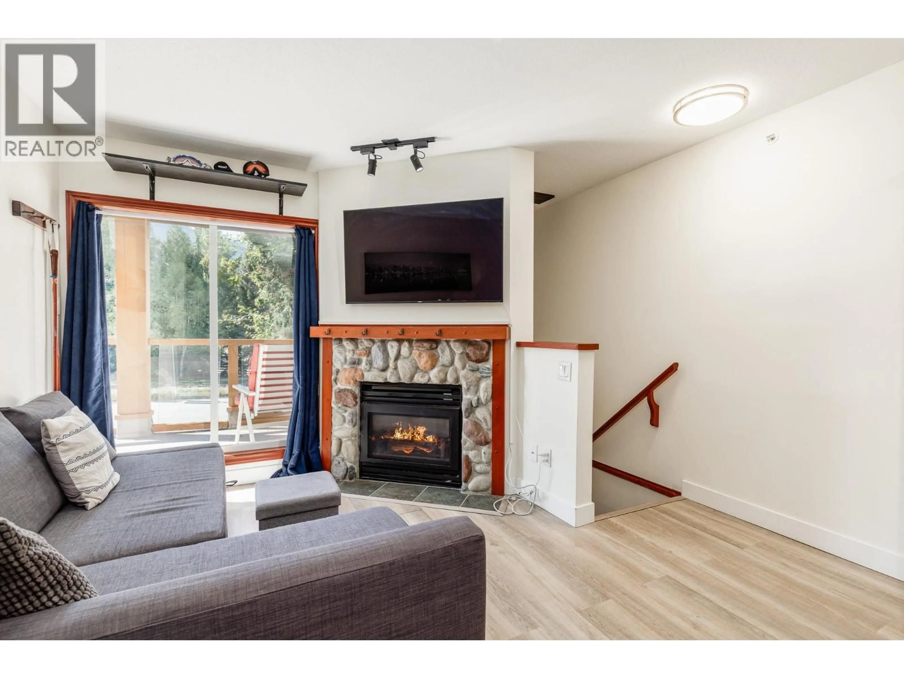 Living room with furniture, wood/laminate floor for 11 - 4388 NORTHLANDS BOULEVARD, Whistler British Columbia V8E1C6