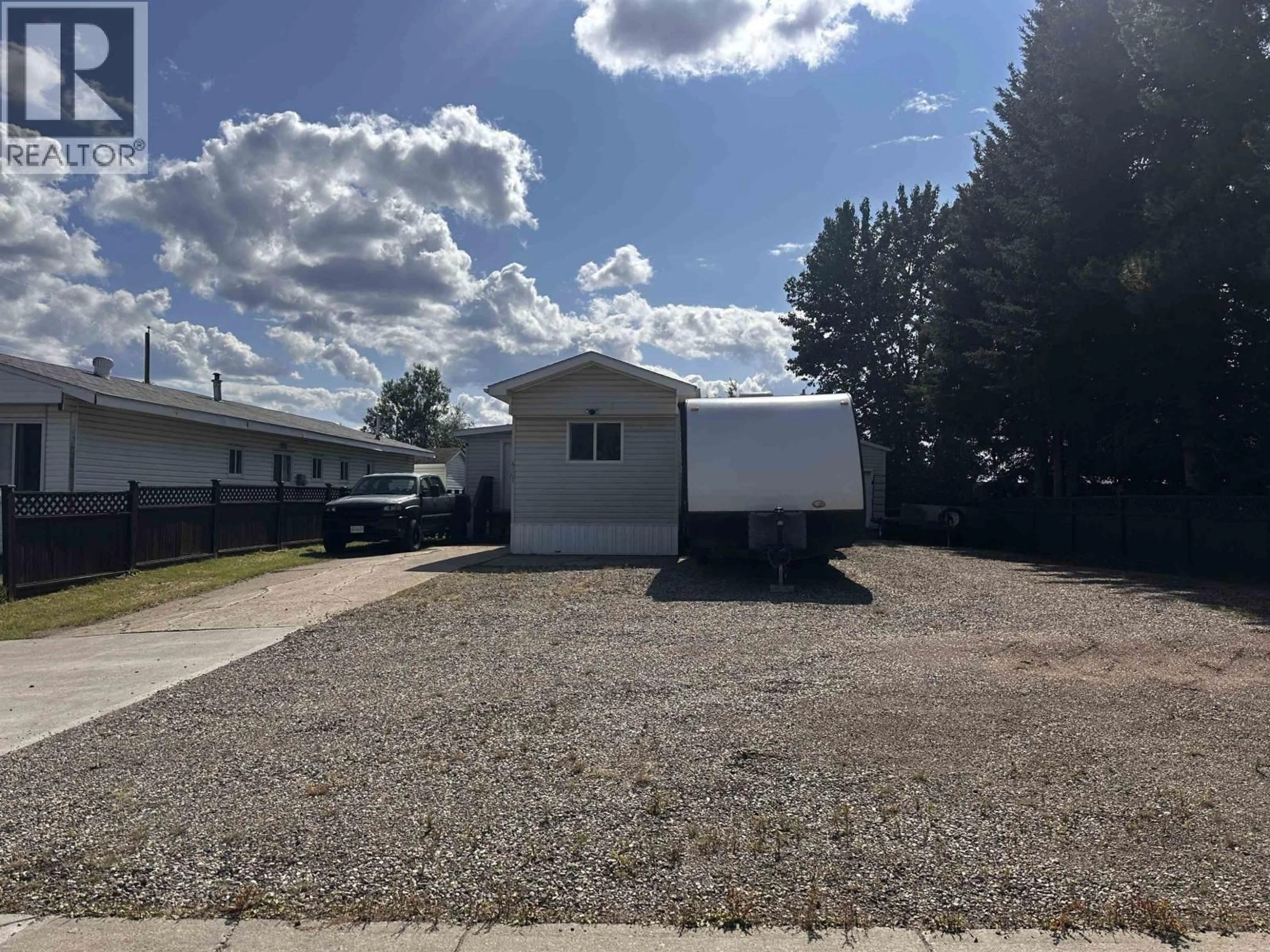 Home with vinyl exterior material, street for 4107 53 AVENUE, Fort Nelson British Columbia V0C1R0