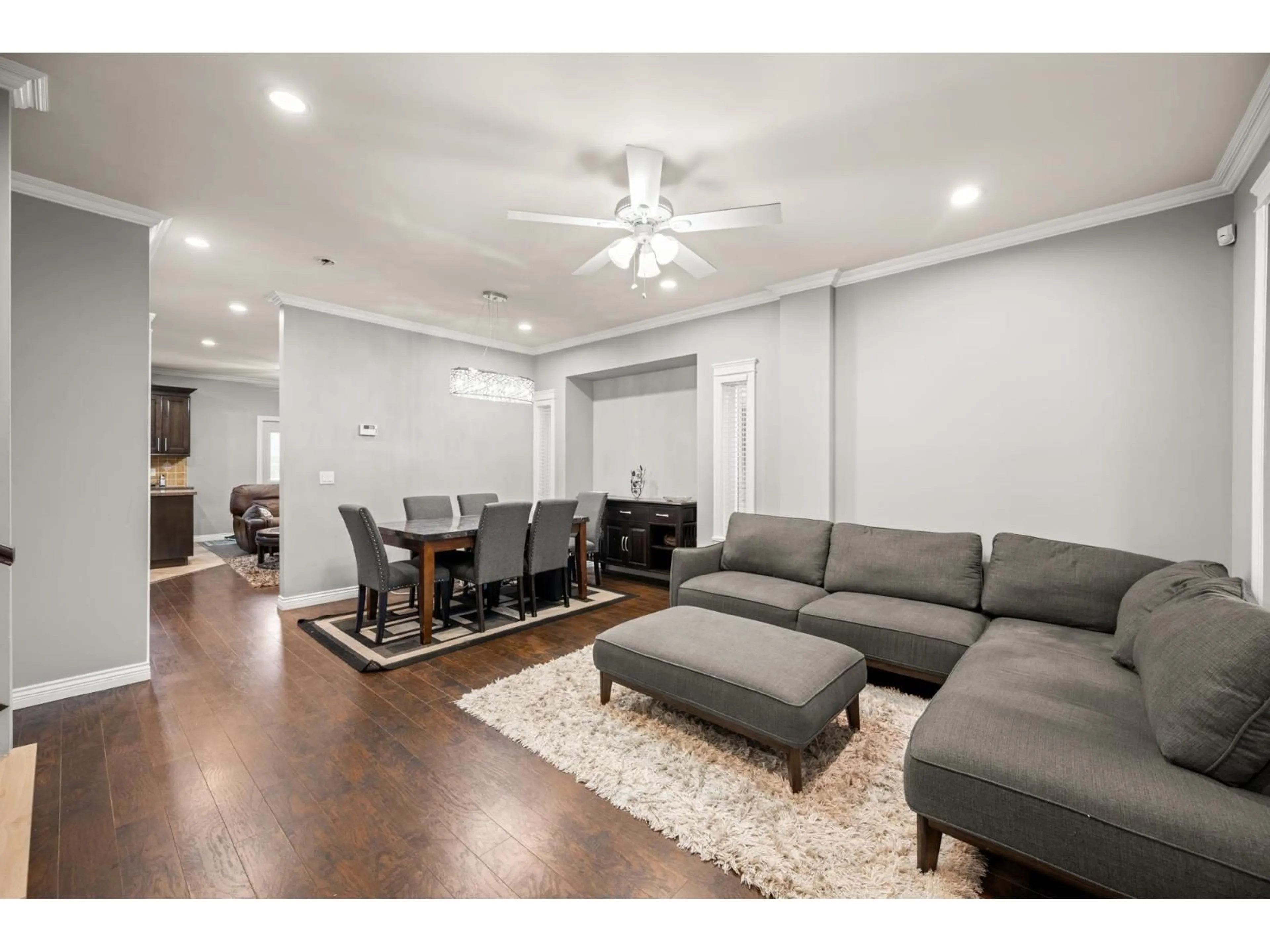Living room with furniture, wood/laminate floor for 7088 144 STREET, Surrey British Columbia V3W5S2