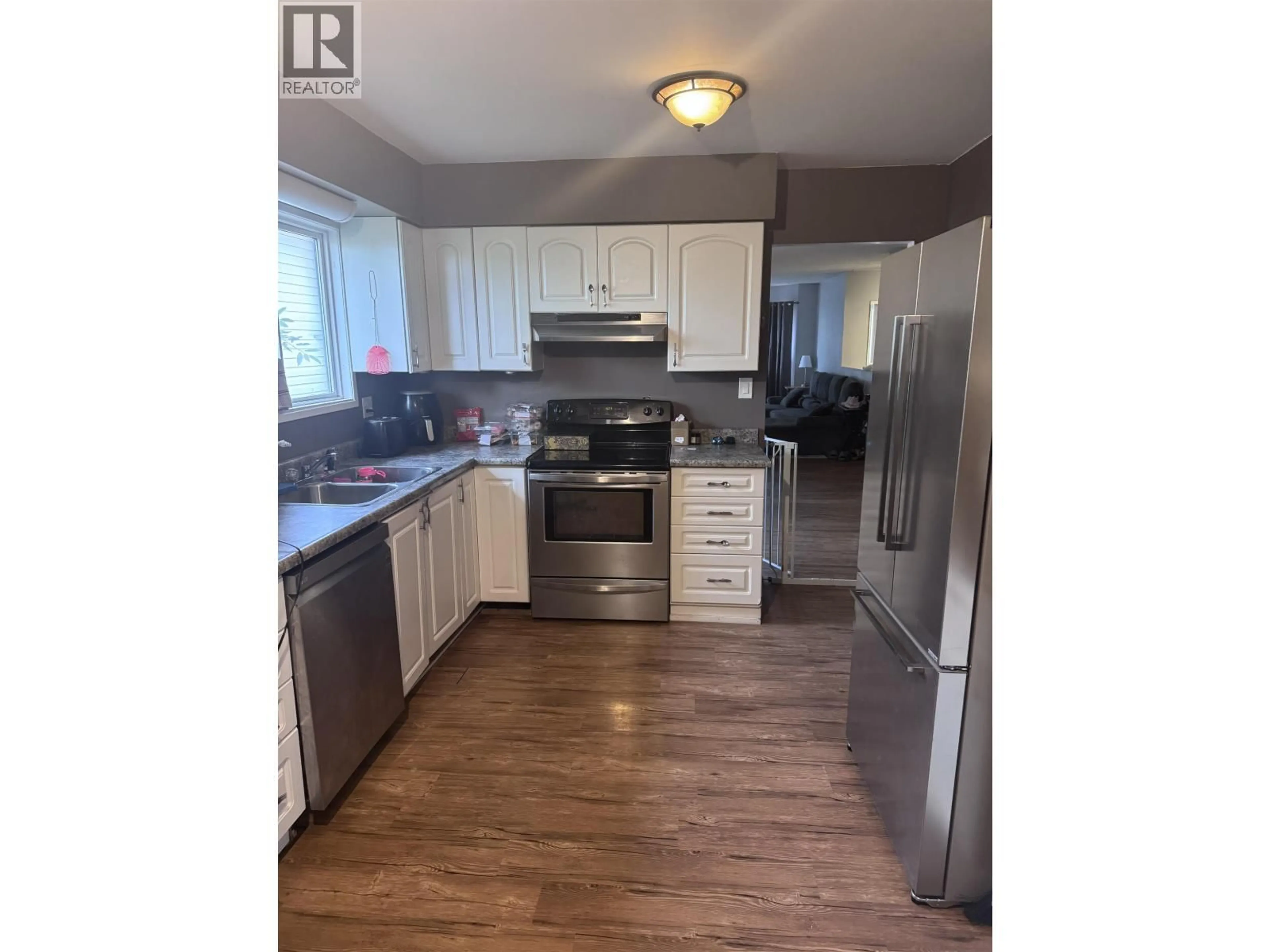 Open concept kitchen, wood/laminate floor for 11404 92 STREET, Fort St. John British Columbia V1J4Y3