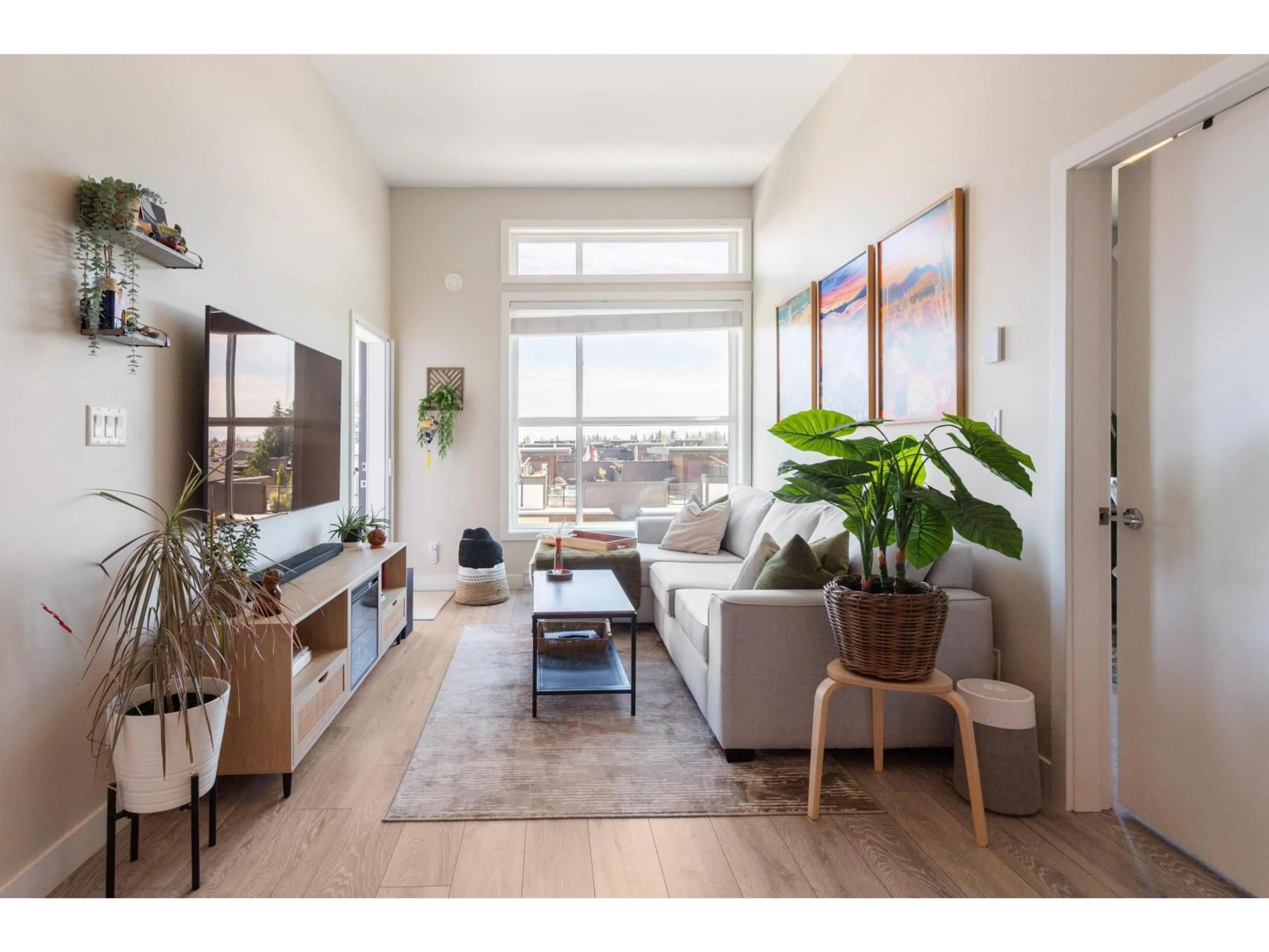 Living room with furniture, wood/laminate floor for 517 - 7809 209 STREET, Langley British Columbia V2Y3N6