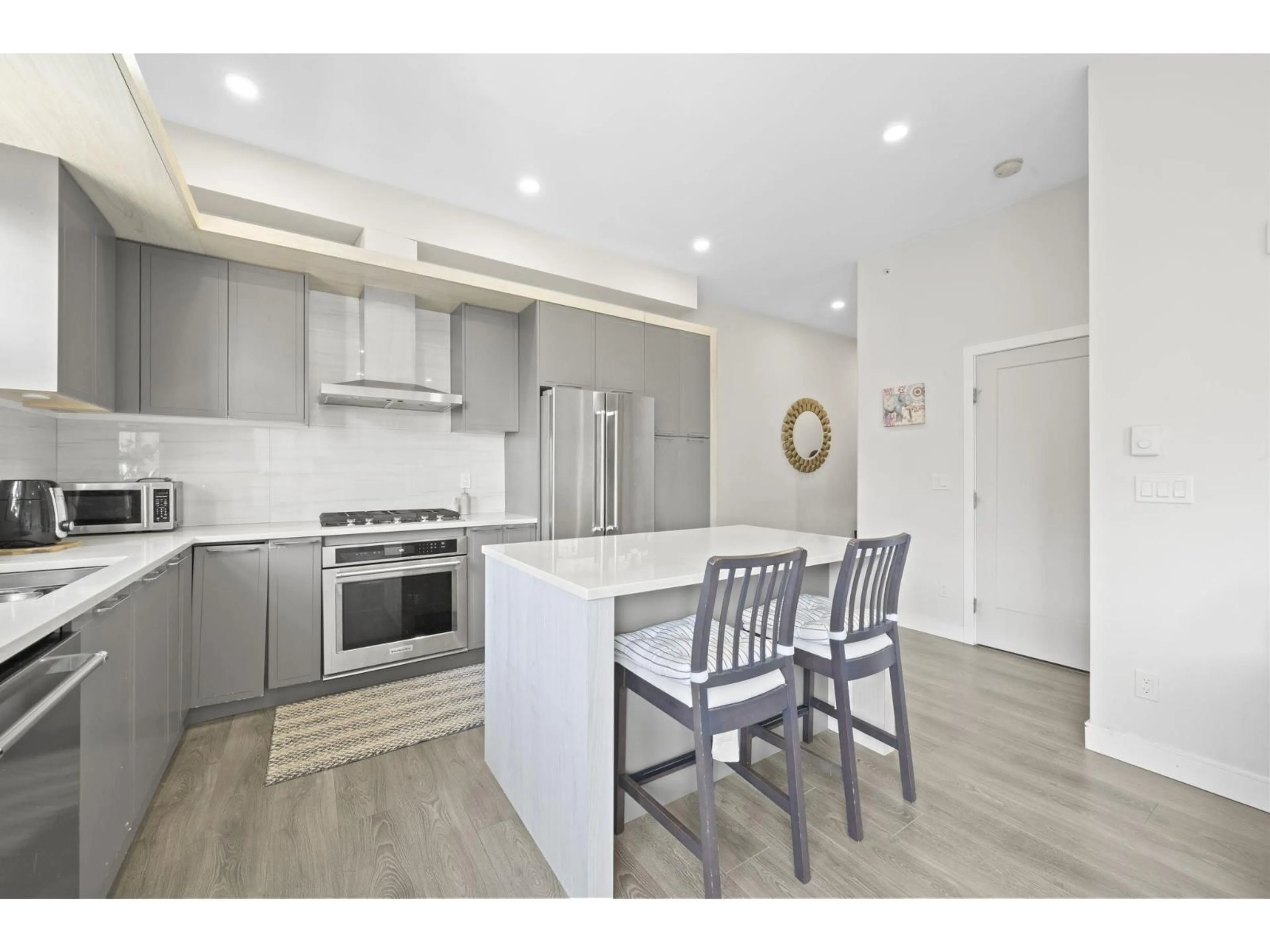 Open concept kitchen, wood/laminate floor for 616 - 11507 84 AVENUE, Delta British Columbia V4C0E5