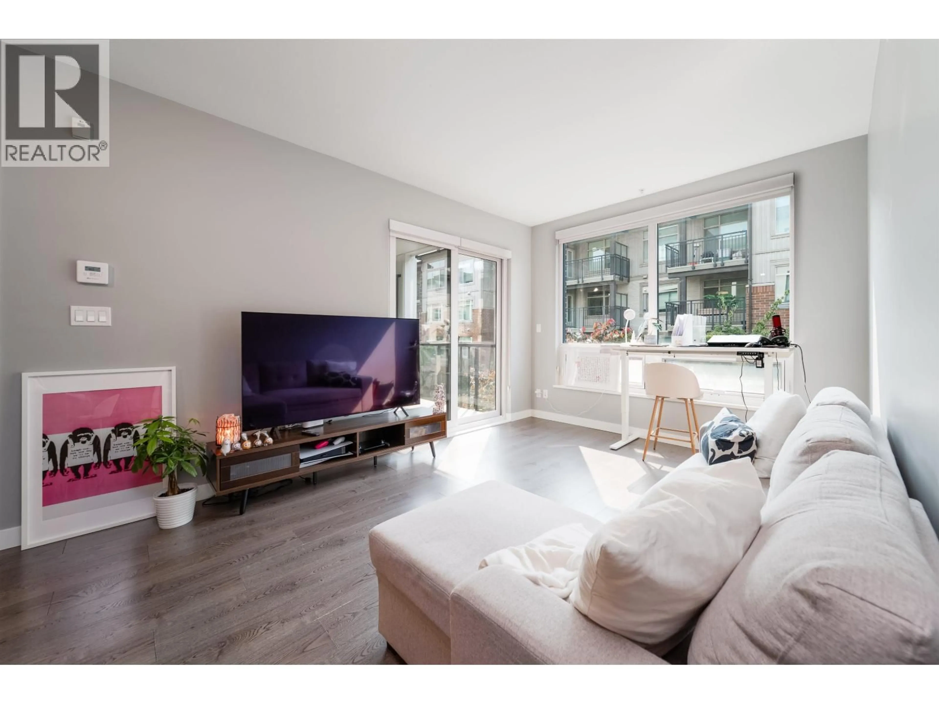 Living room with furniture, wood/laminate floor for 210 - 9333 TOMICKI AVENUE, Richmond British Columbia V6X0L4