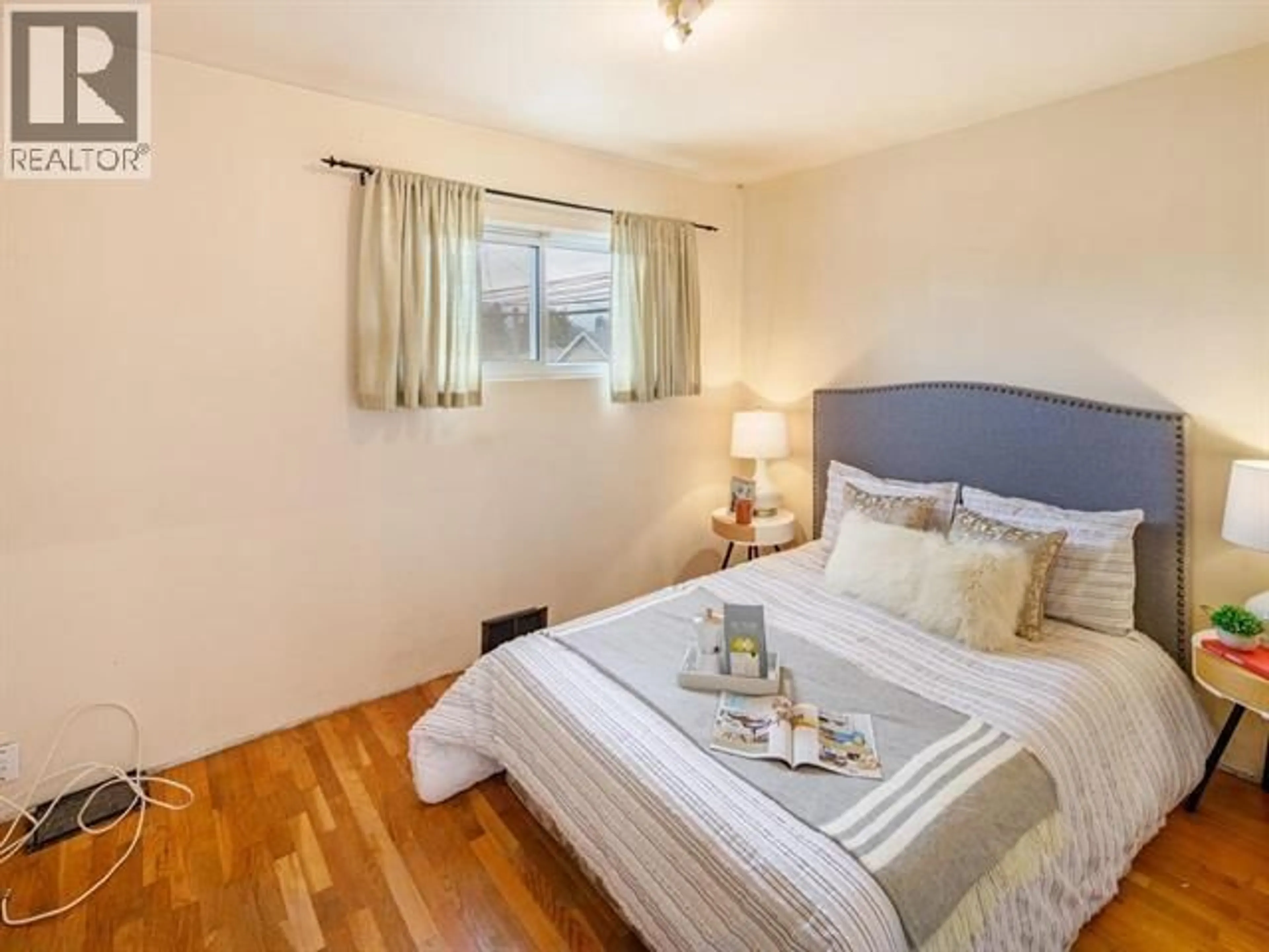 Bedroom with bed, wood/laminate floor for 3687 26TH AVENUE, Vancouver British Columbia V5R1M6