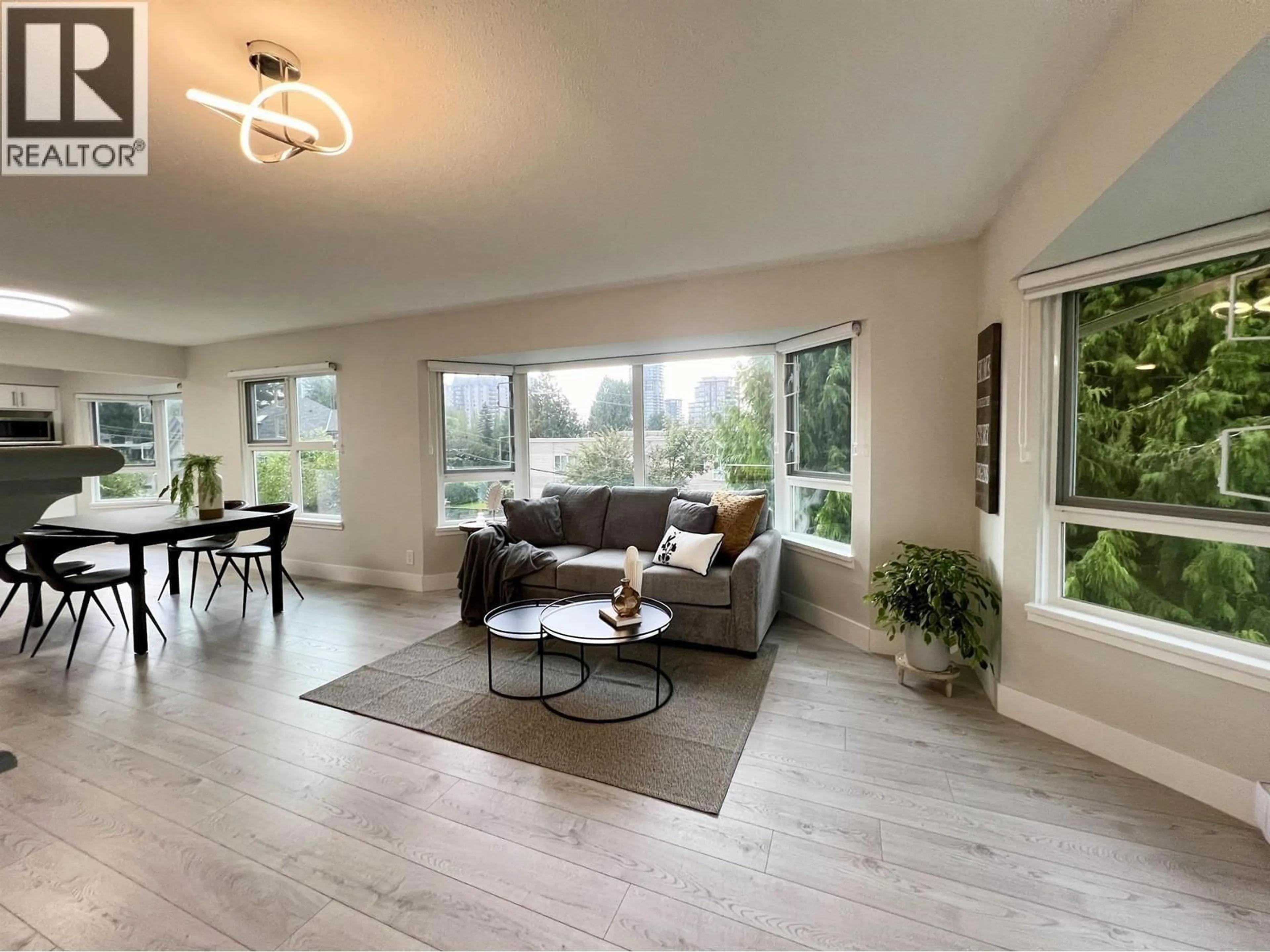 Living room with furniture, wood/laminate floor for 201 - 501 COCHRANE AVENUE, Coquitlam British Columbia V3J7W5