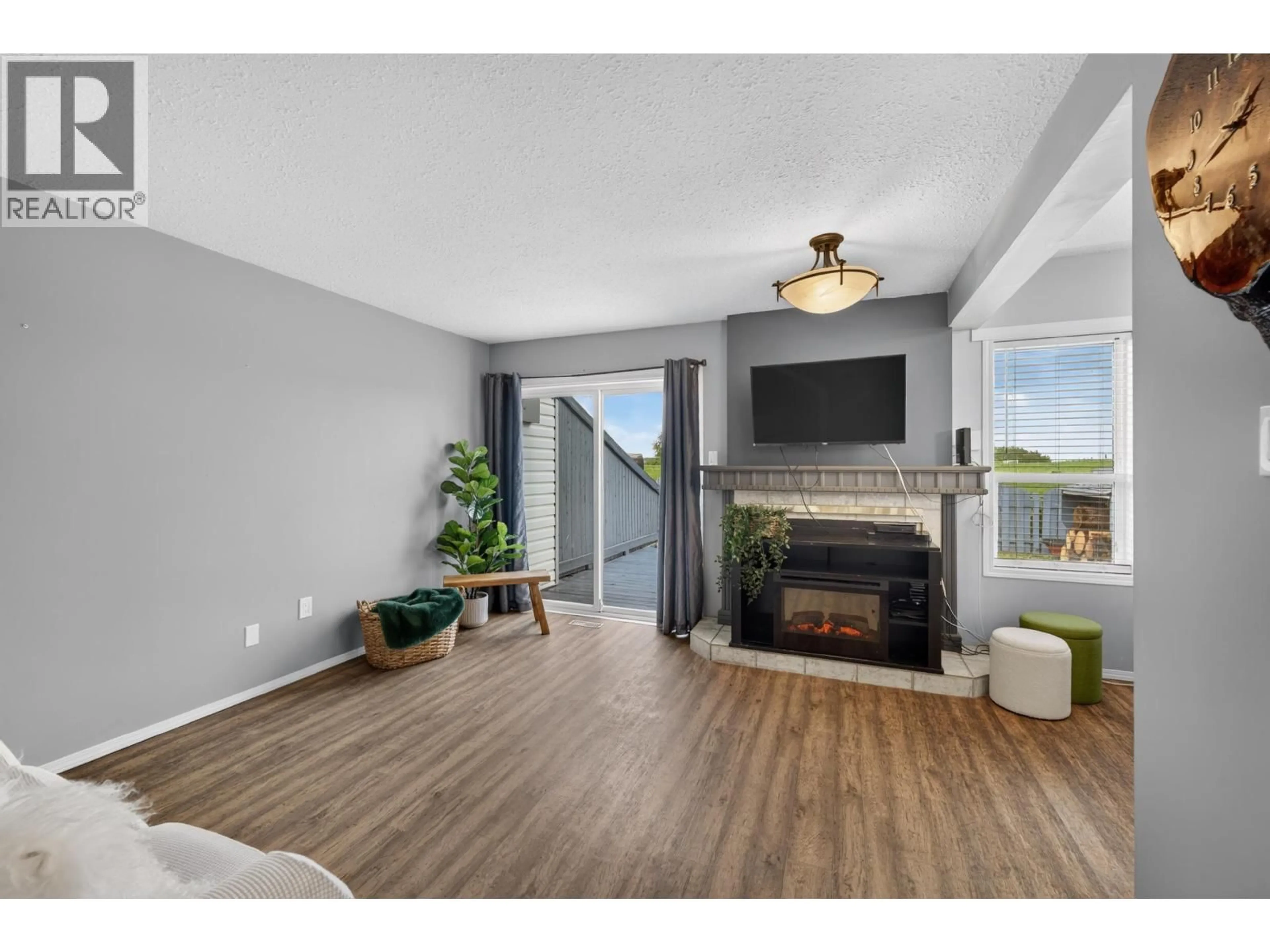 Living room with furniture, wood/laminate floor for 10515 88A STREET, Fort St. John British Columbia V1J5X8