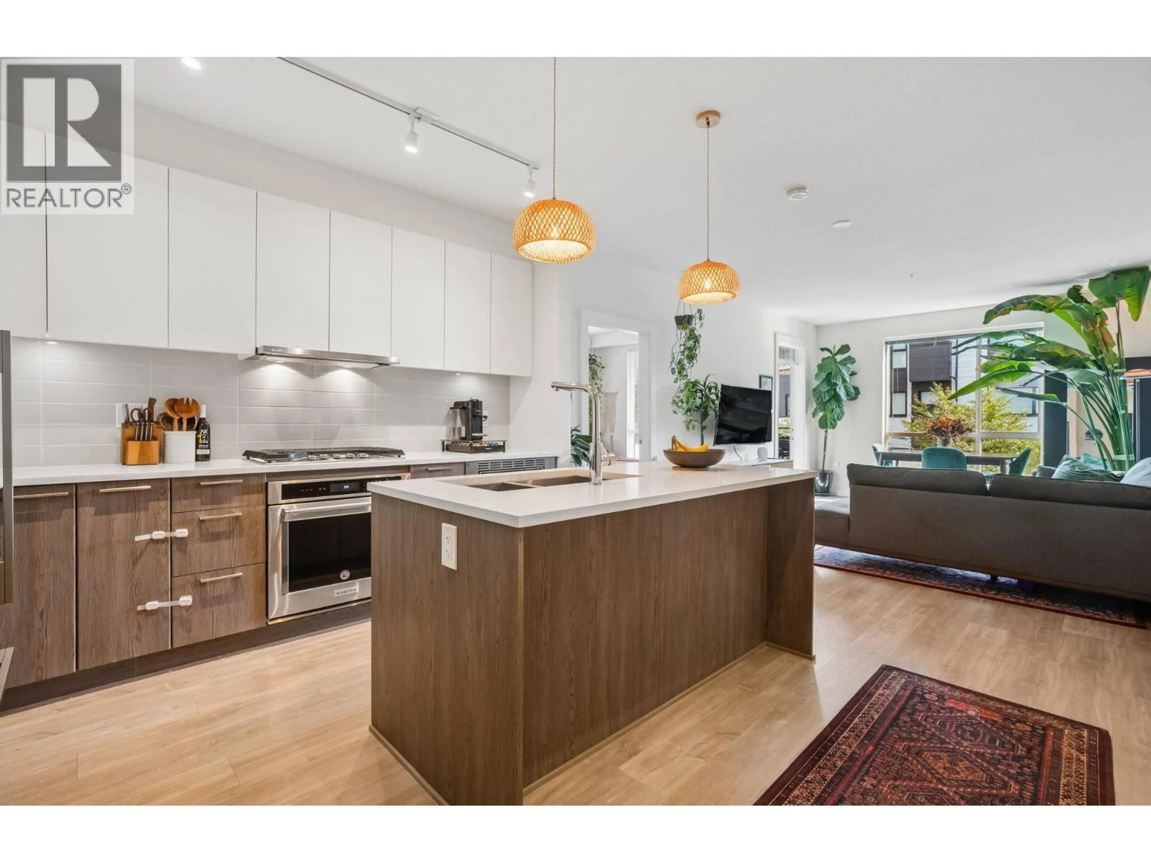 Open concept kitchen, wood/laminate floor for 105 - 625 3RD STREET, North Vancouver British Columbia V7L1G6
