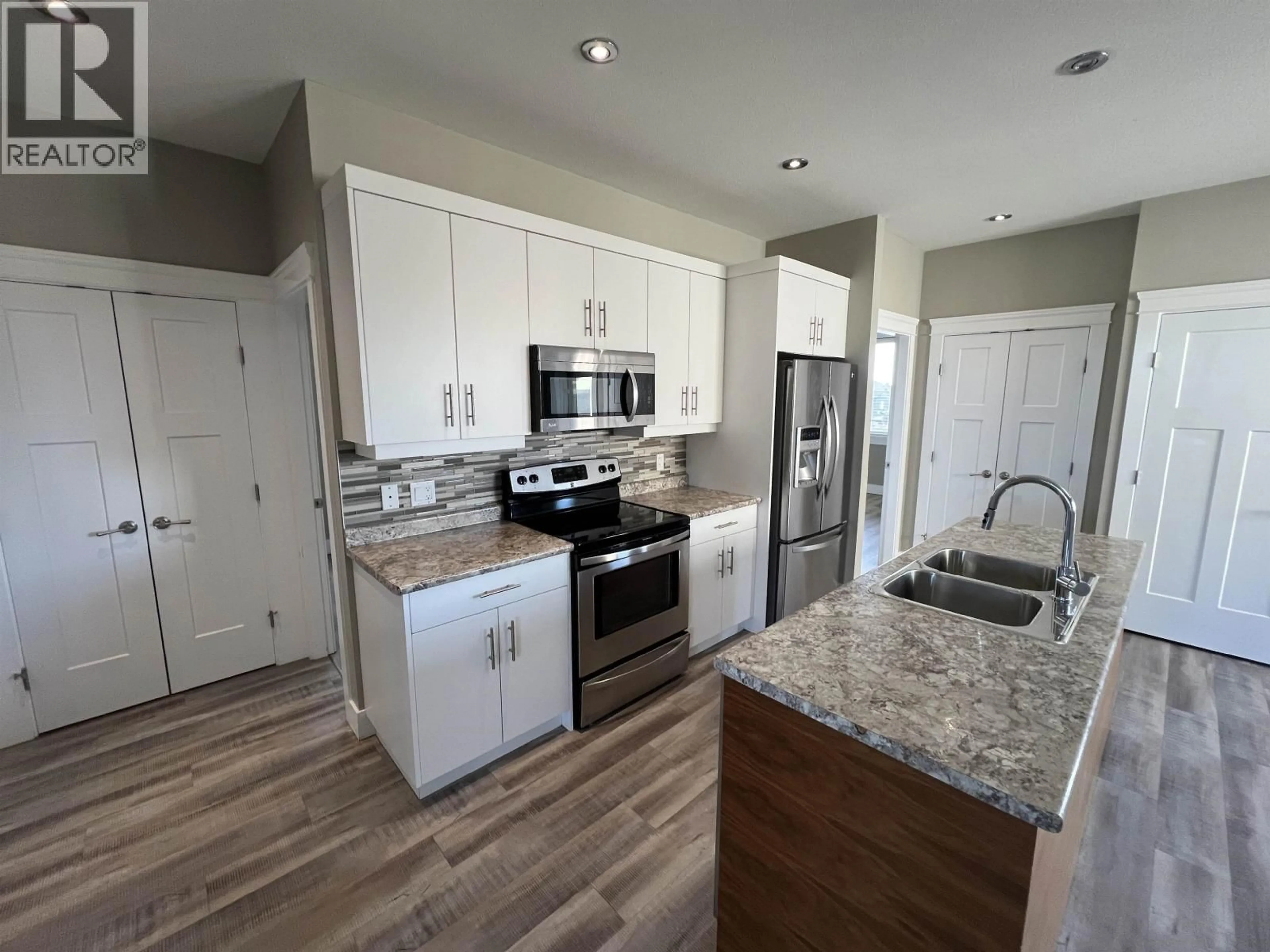 Open concept kitchen, ceramic/tile floor for 8215 88 AVENUE, Fort St. John British Columbia V1J0N9