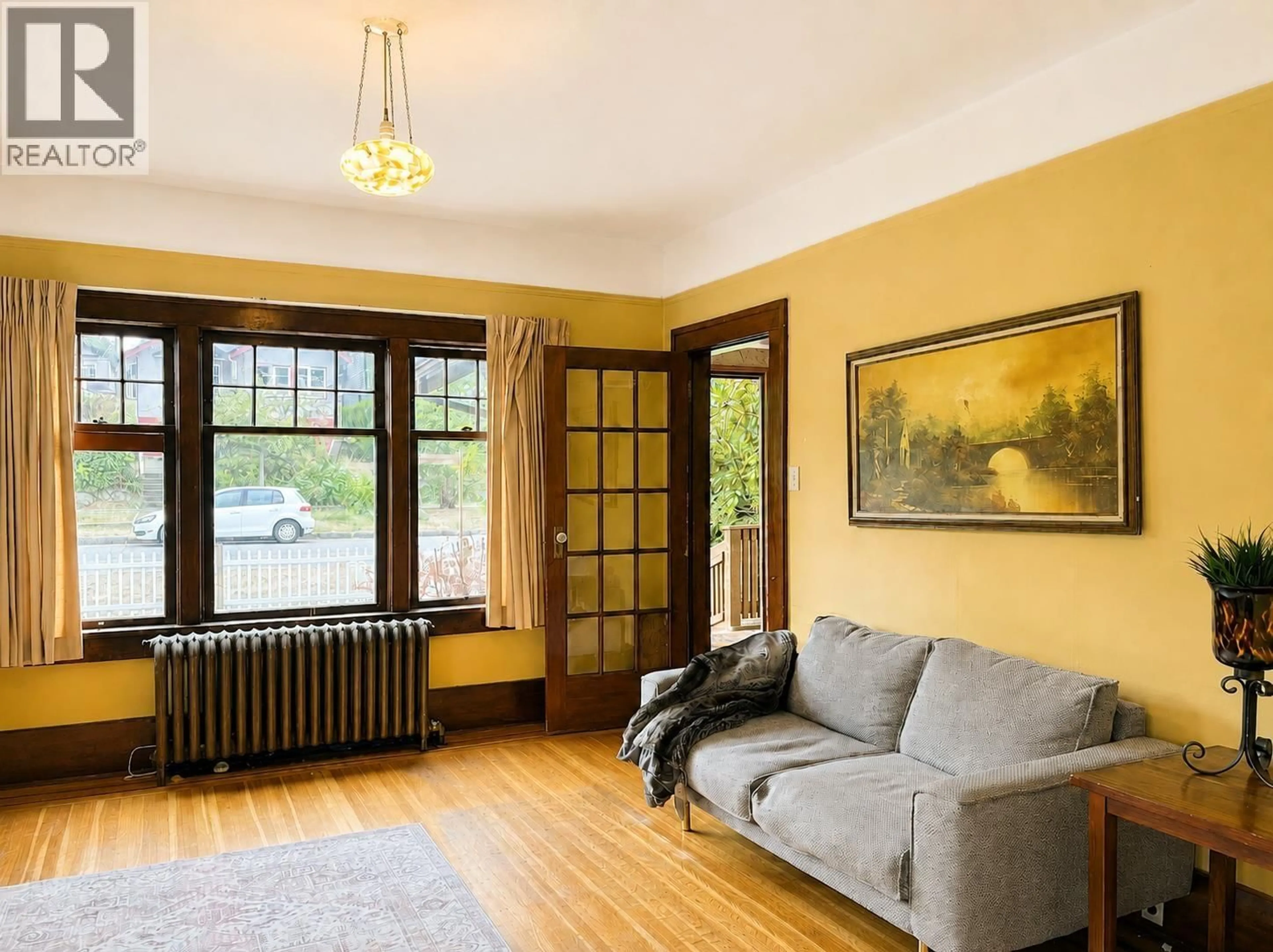 Living room with furniture, wood/laminate floor for 4117 11TH AVENUE, Vancouver British Columbia V6R2L5