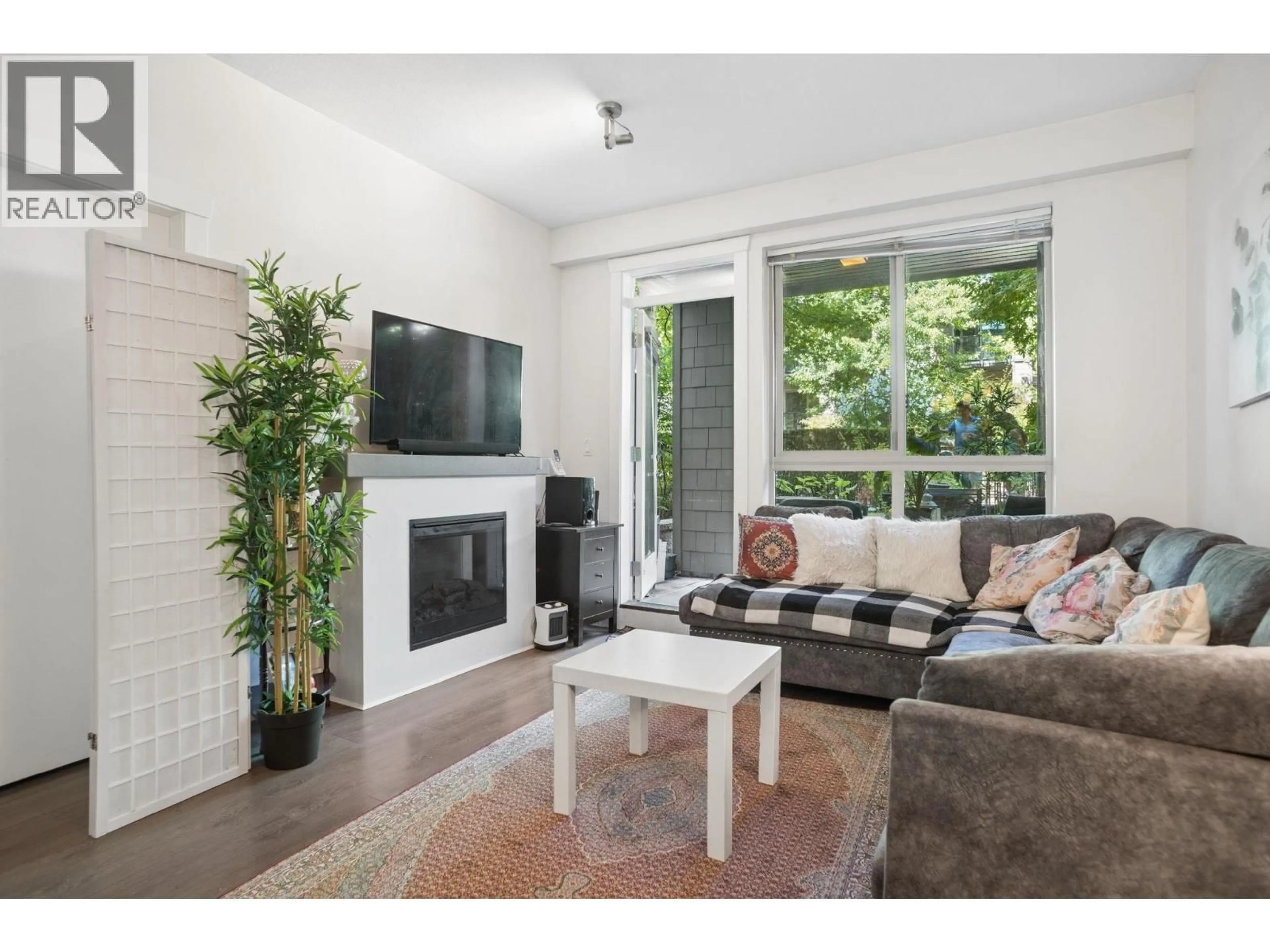 Living room with furniture, wood/laminate floor for 107 - 7478 BYRNEPARK WALK, Burnaby British Columbia V3N0B5