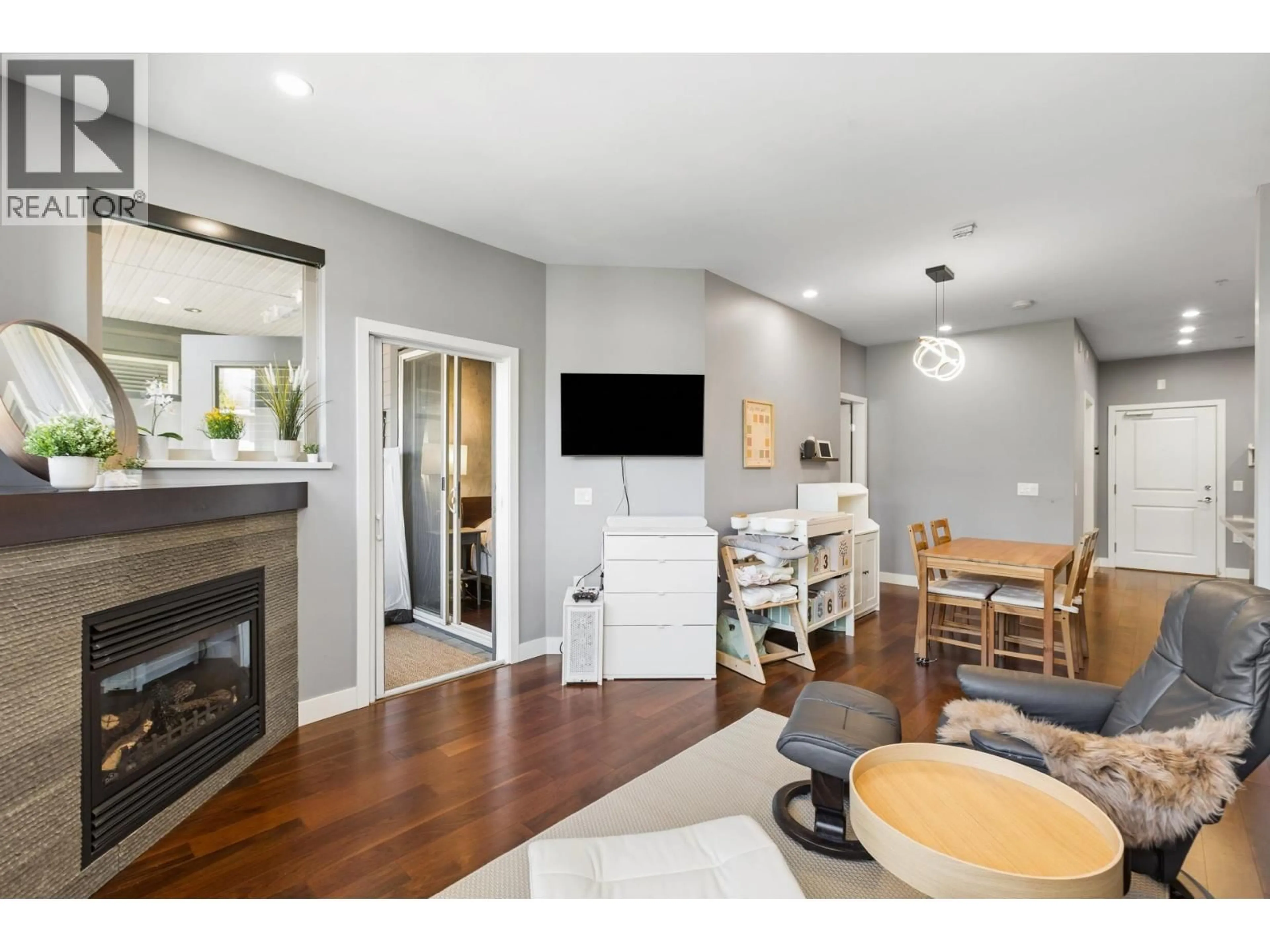 Living room with furniture, wood/laminate floor for 303 - 116 23RD STREET, North Vancouver British Columbia V7M2A9