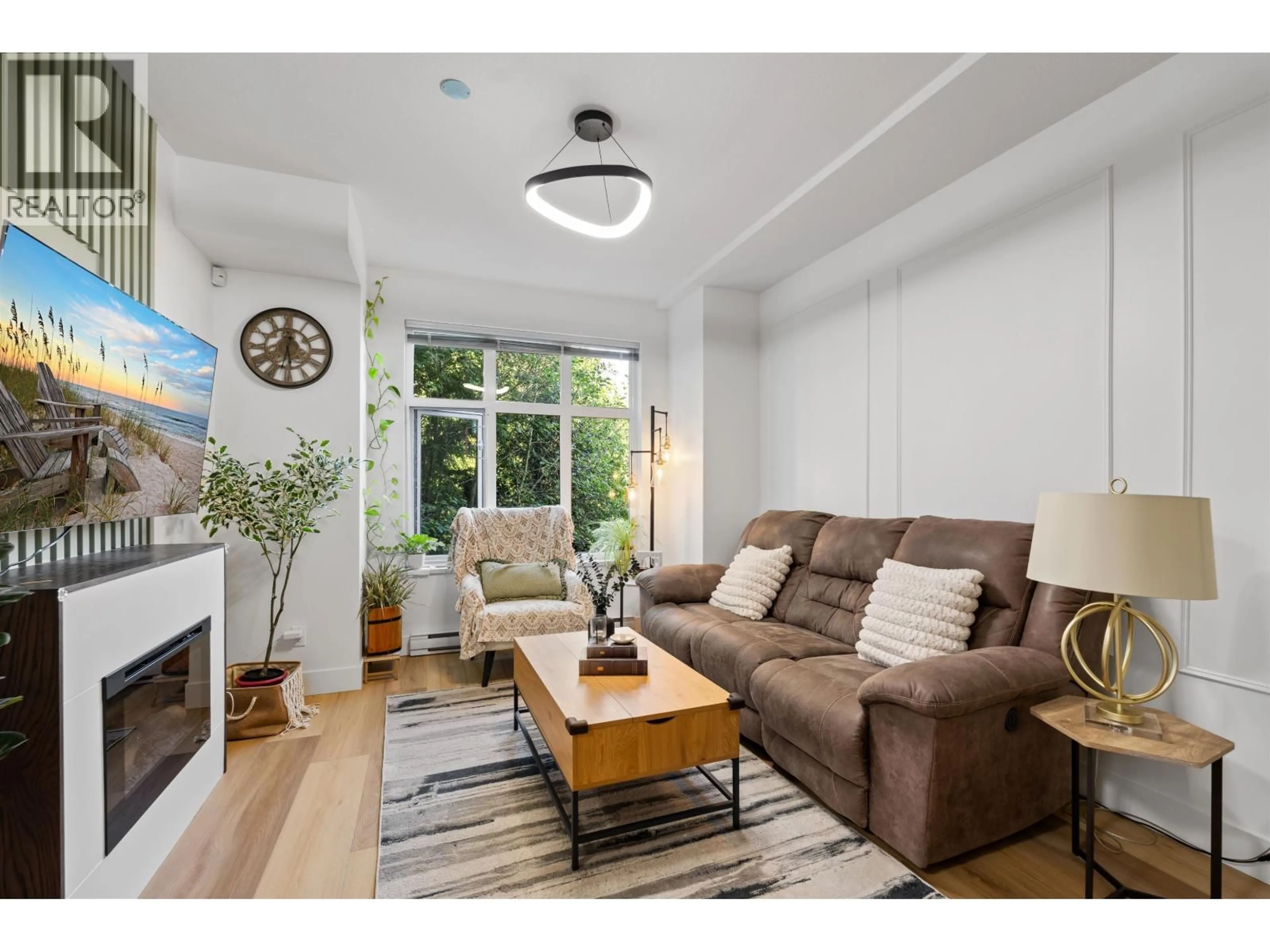 Living room with furniture, wood/laminate floor for 703 - 8485 NEW HAVEN CLOSE, Burnaby British Columbia V5J0B7