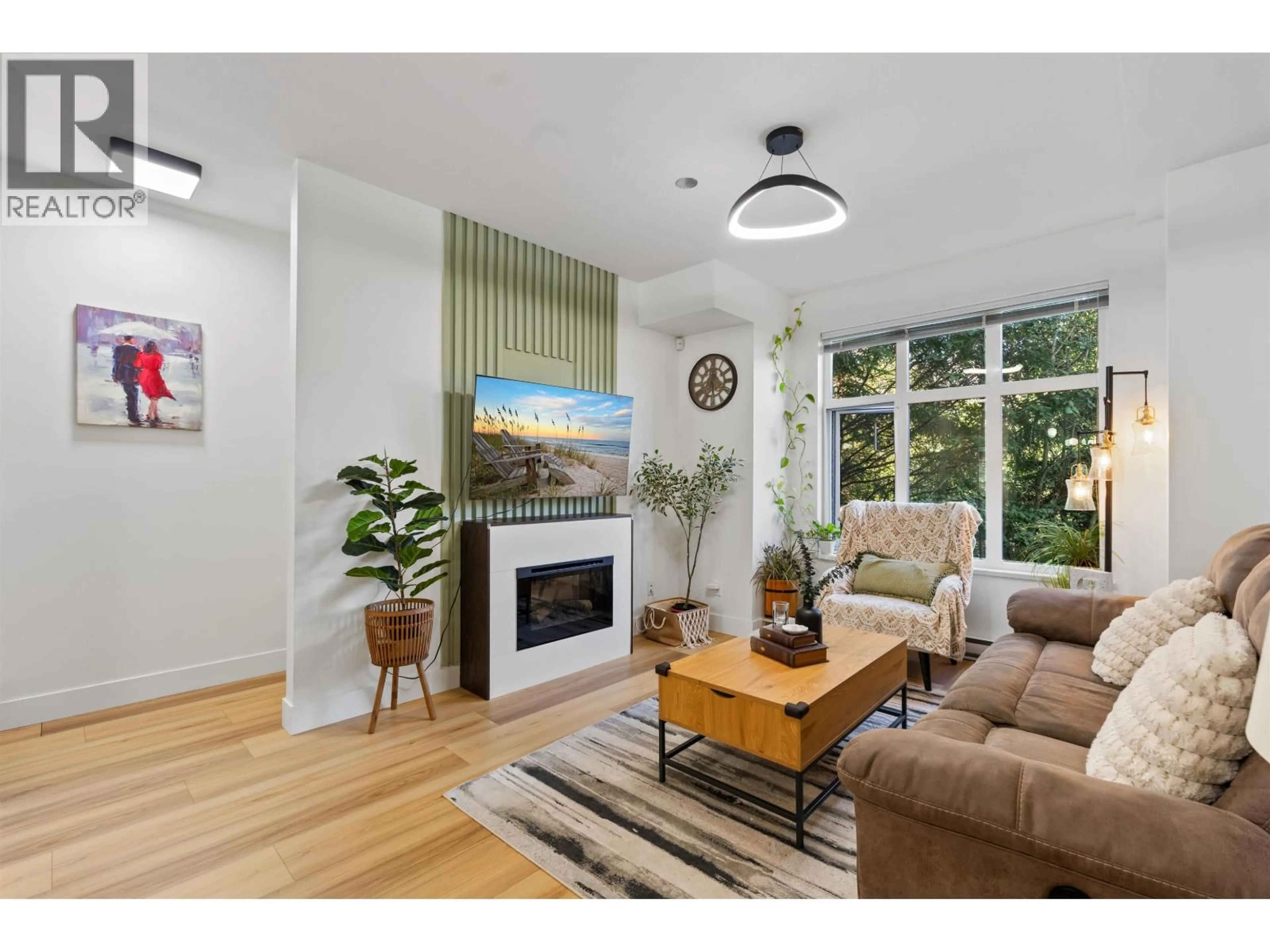 Living room with furniture, wood/laminate floor for 703 - 8485 NEW HAVEN CLOSE, Burnaby British Columbia V5J0B7