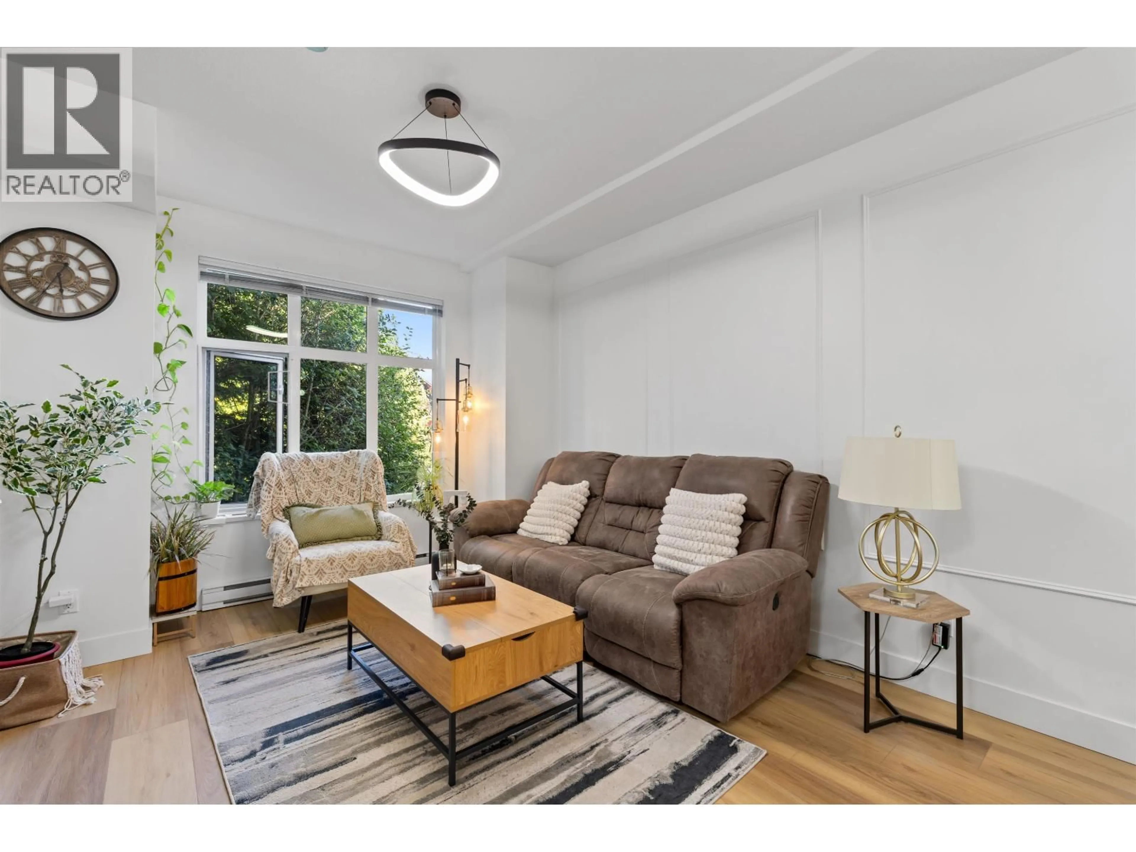 Living room with furniture, wood/laminate floor for 703 - 8485 NEW HAVEN CLOSE, Burnaby British Columbia V5J0B7