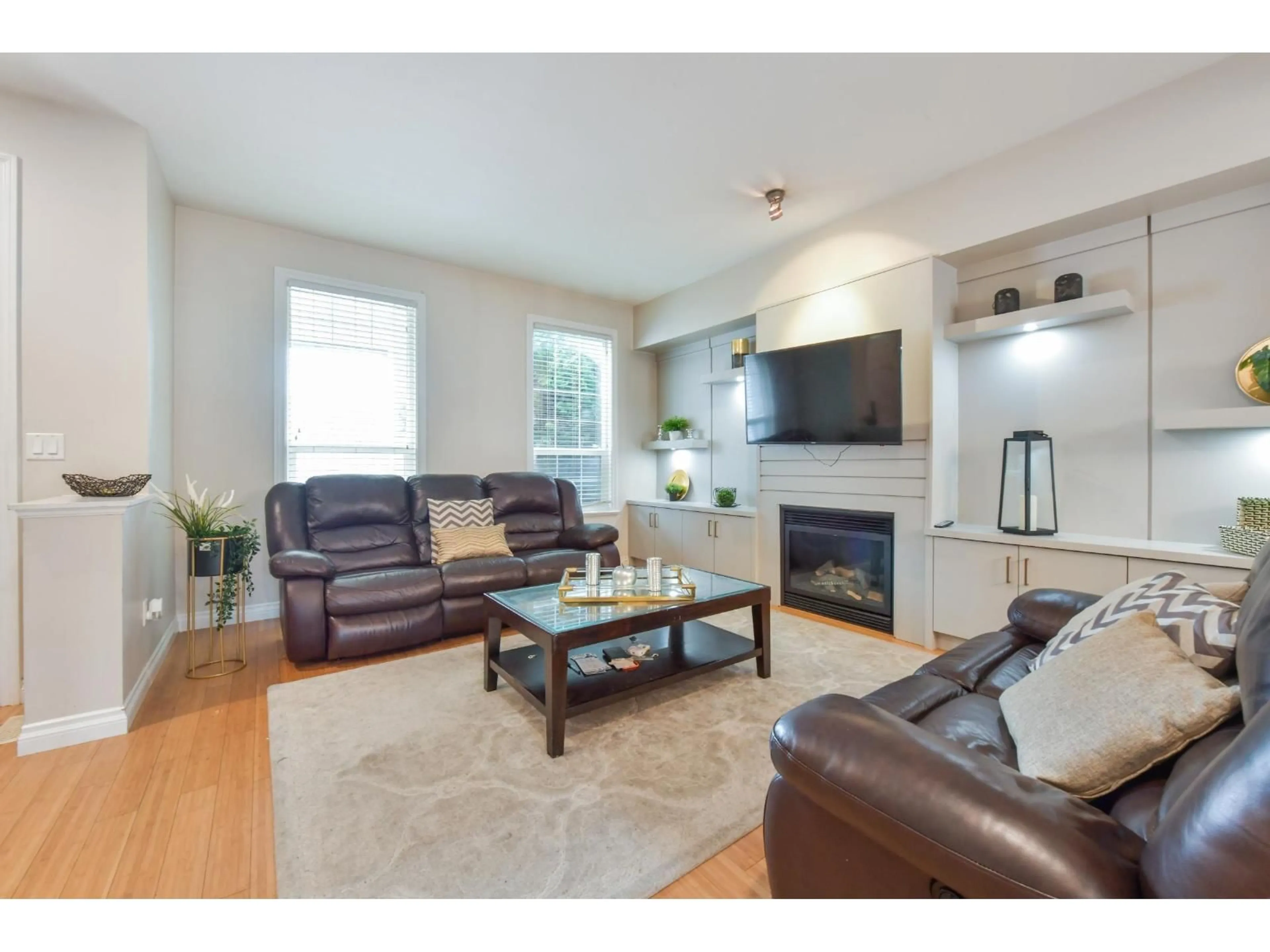Living room with furniture, wood/laminate floor for 18043 70 AVENUE, Surrey British Columbia V3S6X3