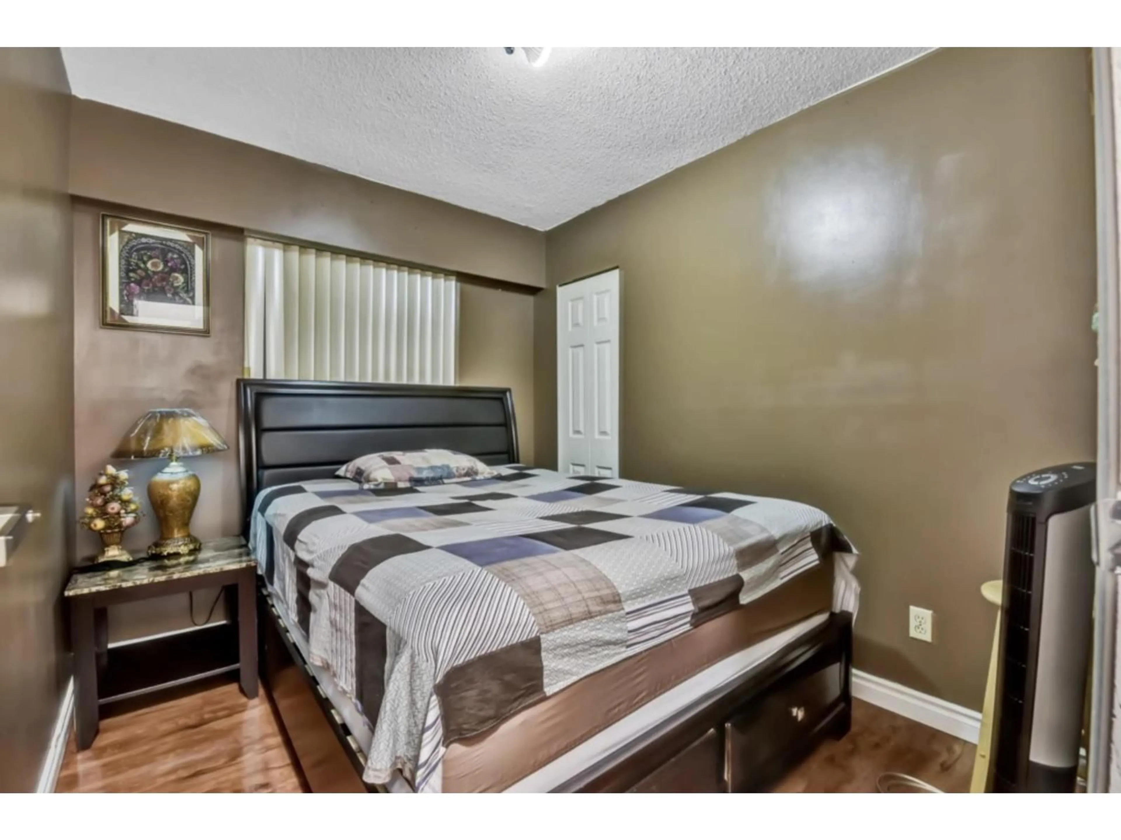 Bedroom with bed, wood/laminate floor for 12215 85A AVENUE, Surrey British Columbia V3W6G8