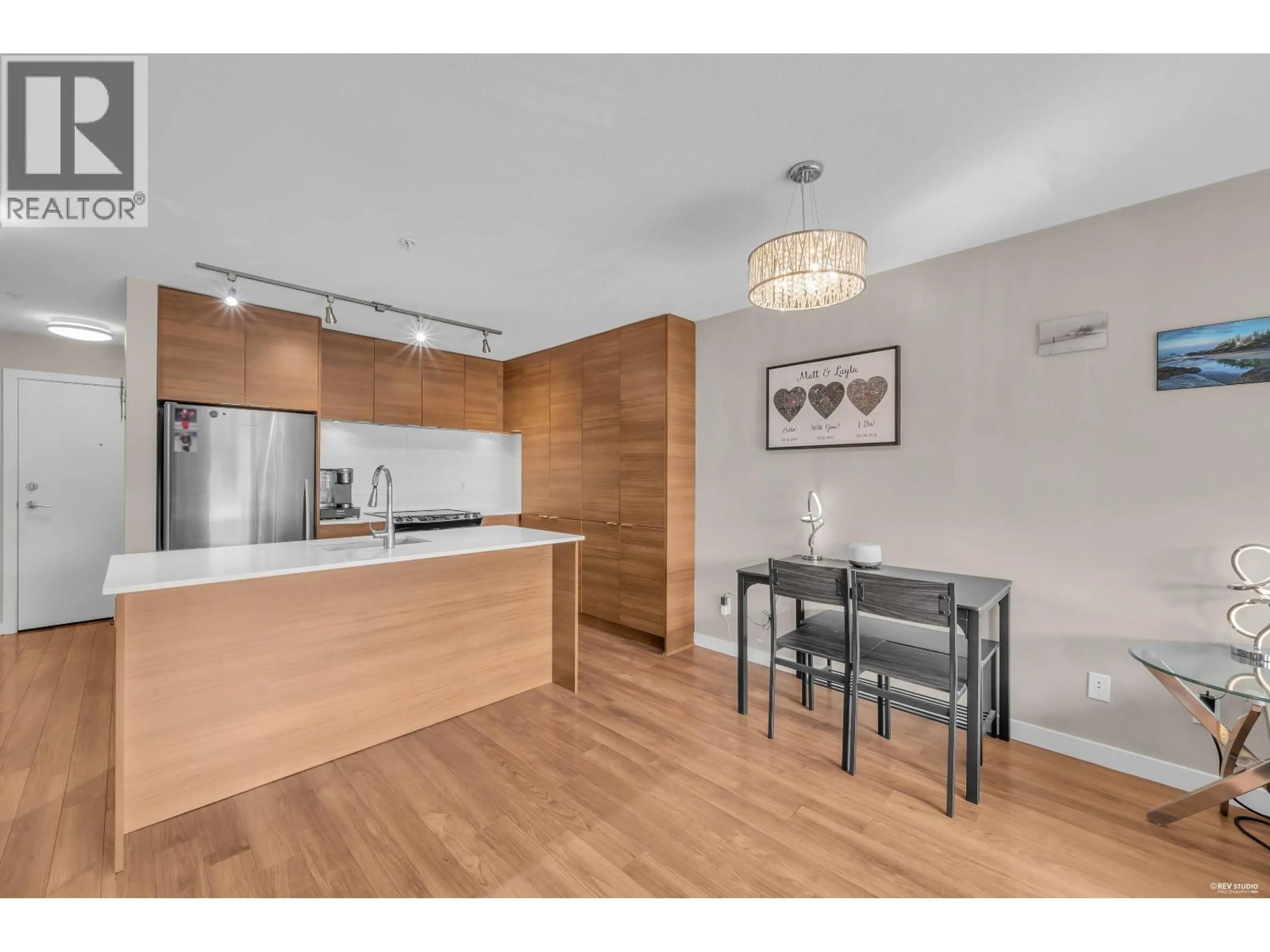 Open concept kitchen, wood/laminate floor for 401 - 1677 LLOYD AVENUE, North Vancouver British Columbia V7P0B1