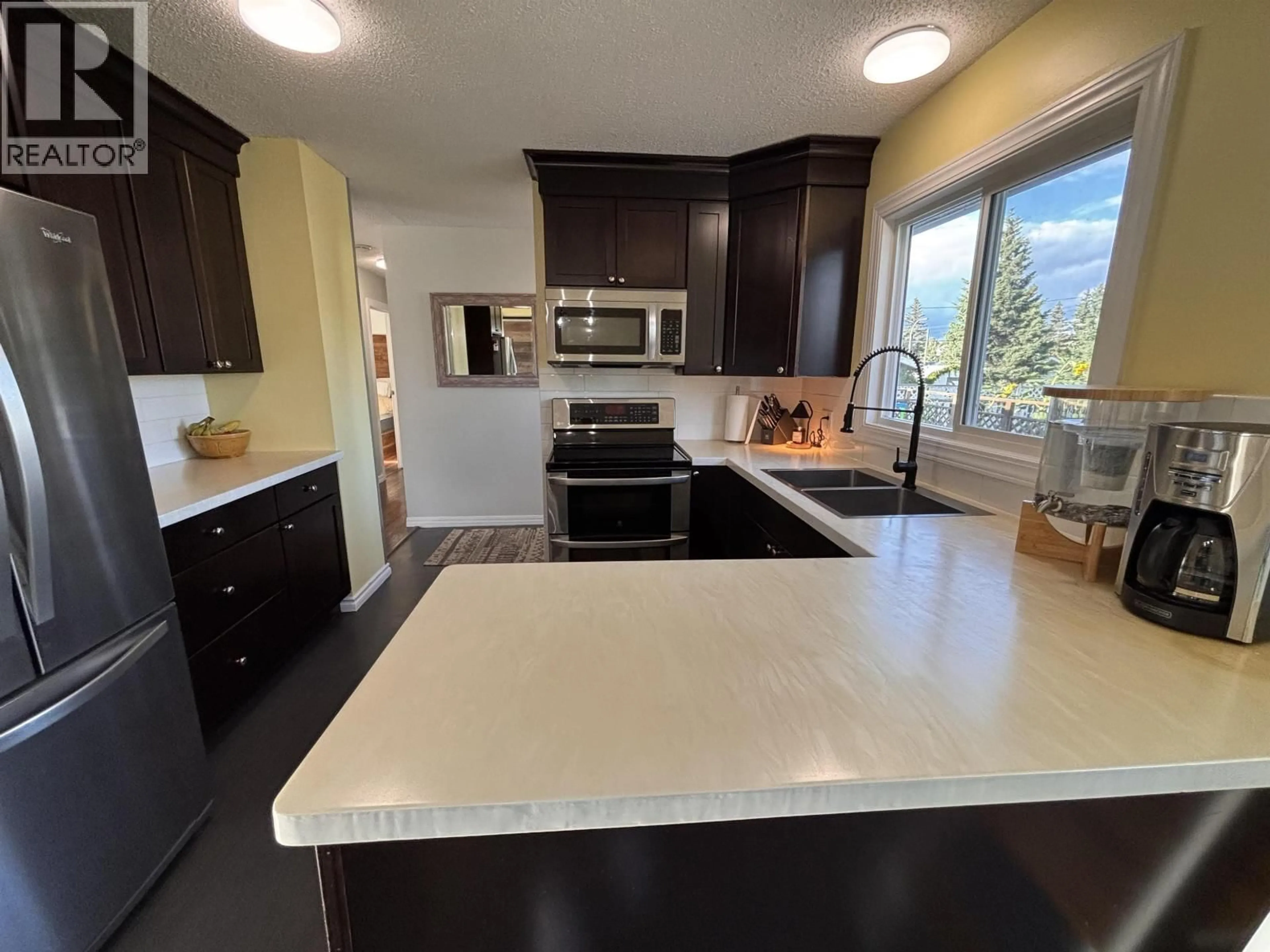 Open concept kitchen, ceramic/tile floor for 8611 90 STREET, Fort St. John British Columbia V1J4R5