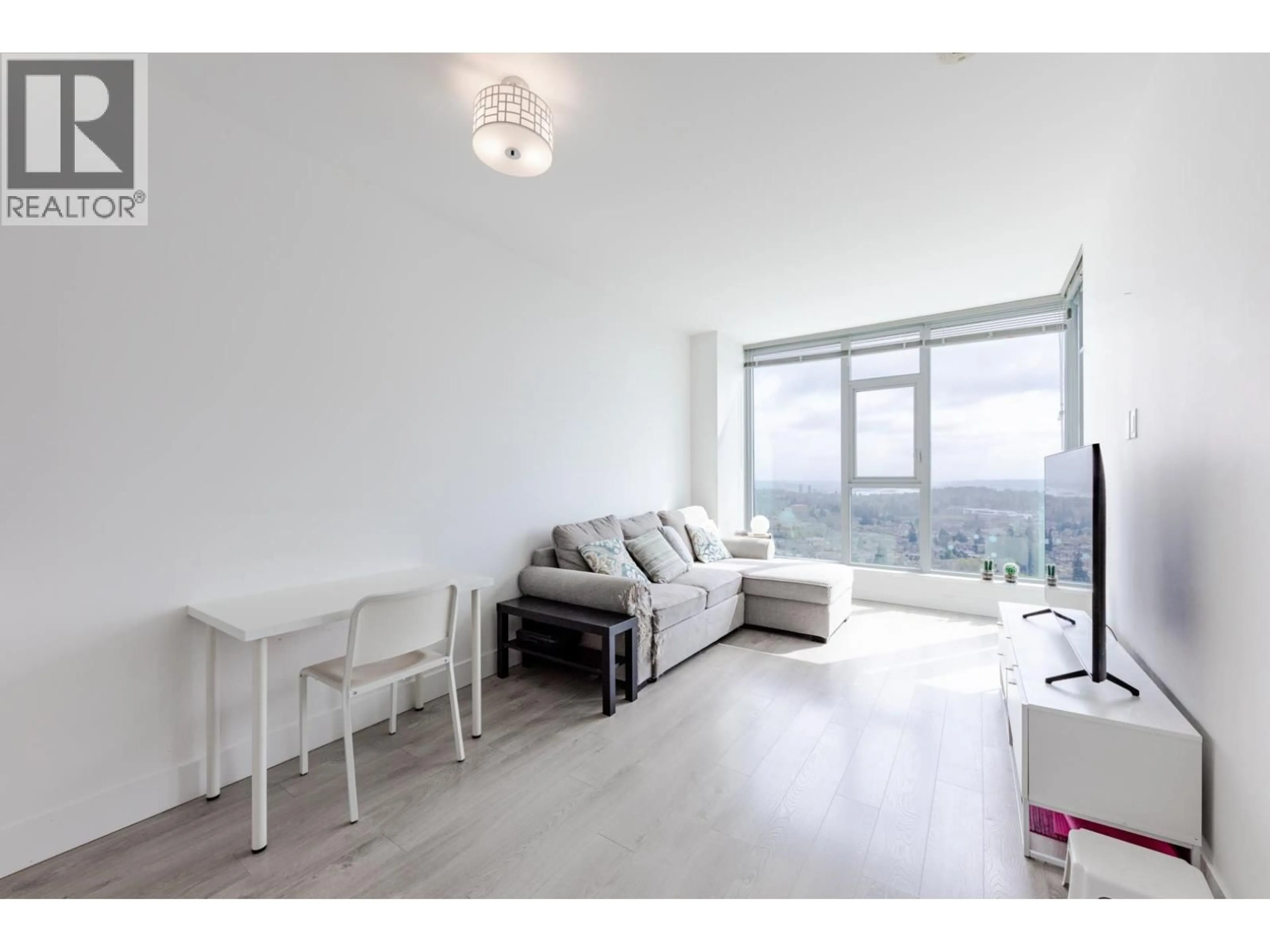 Living room with furniture, wood/laminate floor for 3006 - 7388 KINGSWAY, Burnaby British Columbia V3N0G9