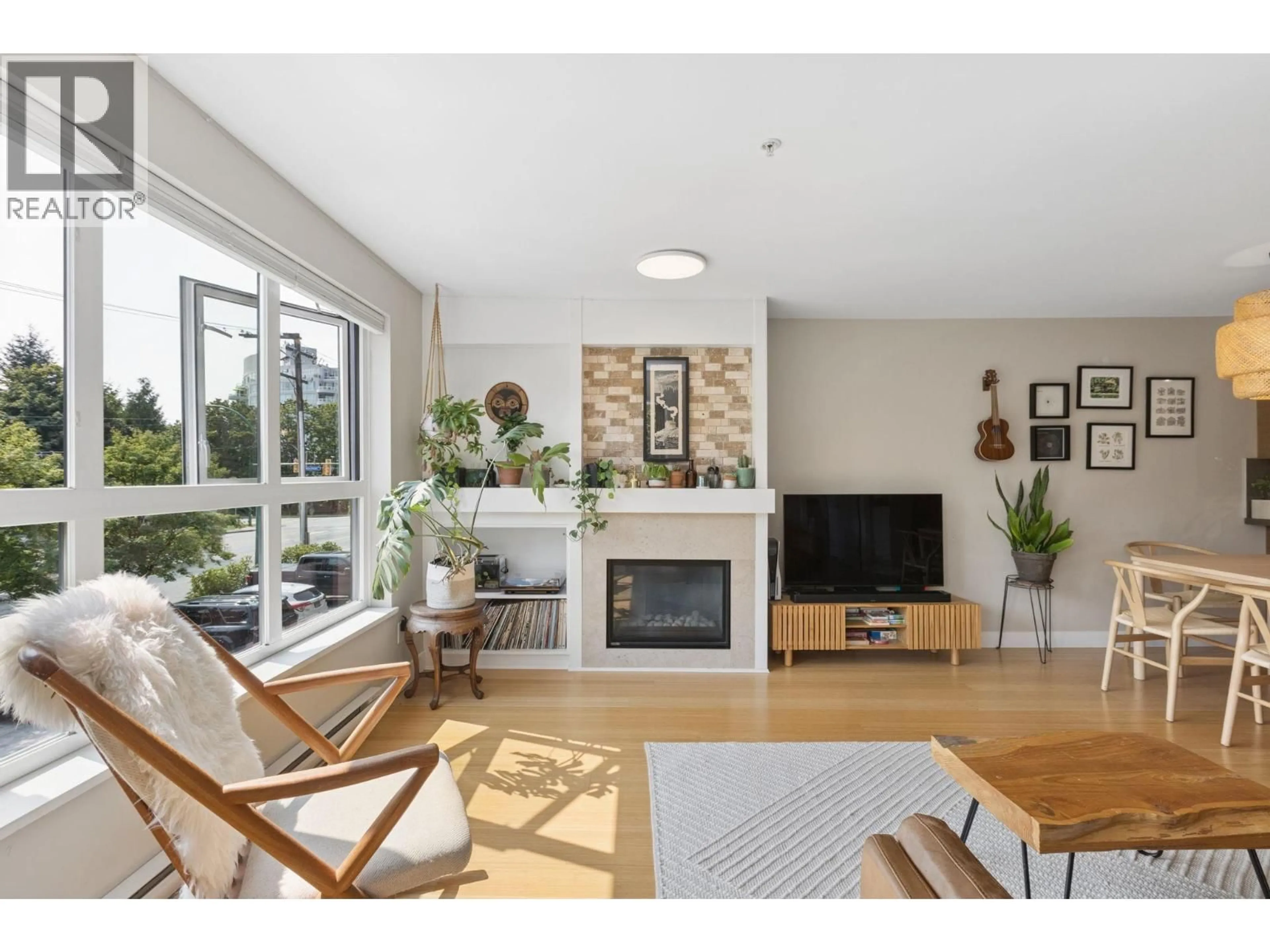 Living room with furniture, wood/laminate floor for 207 - 3732 MT SEYMOUR PARKWAY, North Vancouver British Columbia V7G1C3
