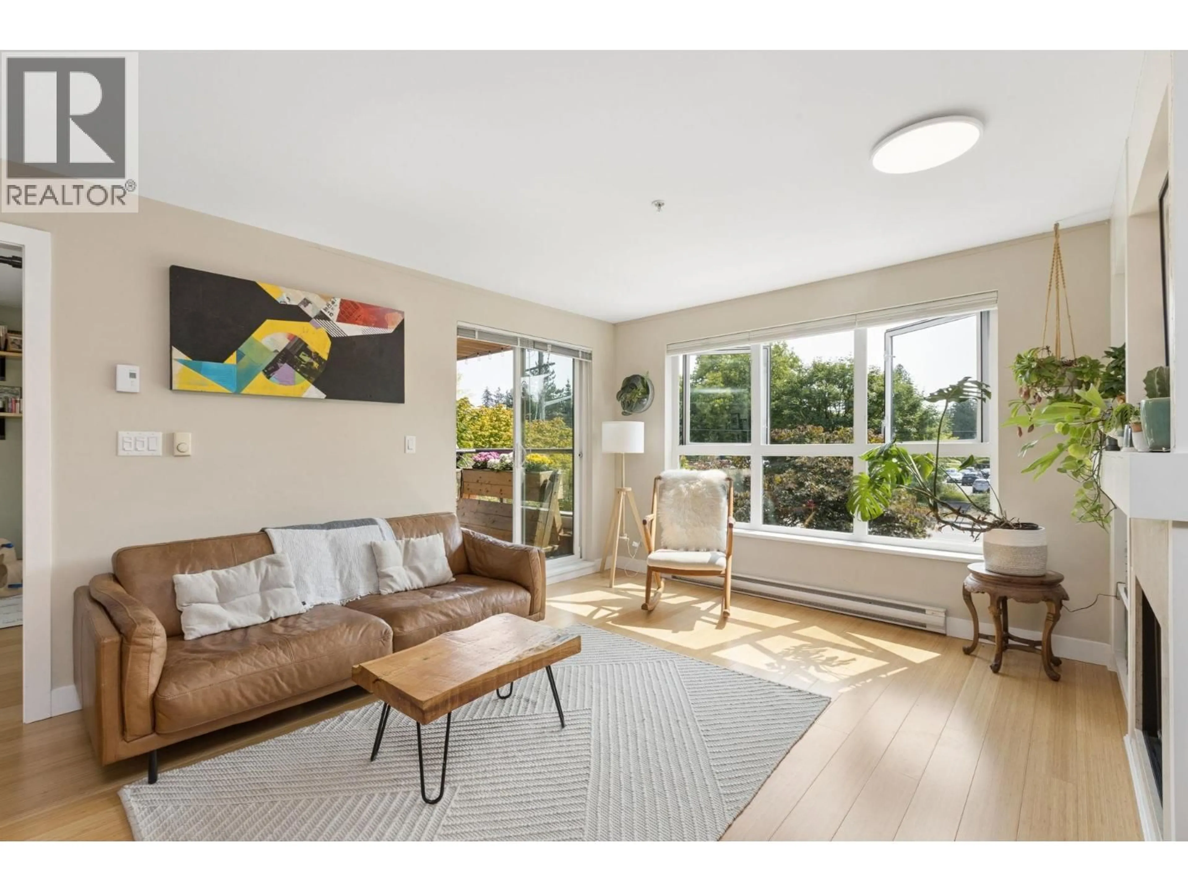 Living room with furniture, wood/laminate floor for 207 - 3732 MT SEYMOUR PARKWAY, North Vancouver British Columbia V7G1C3