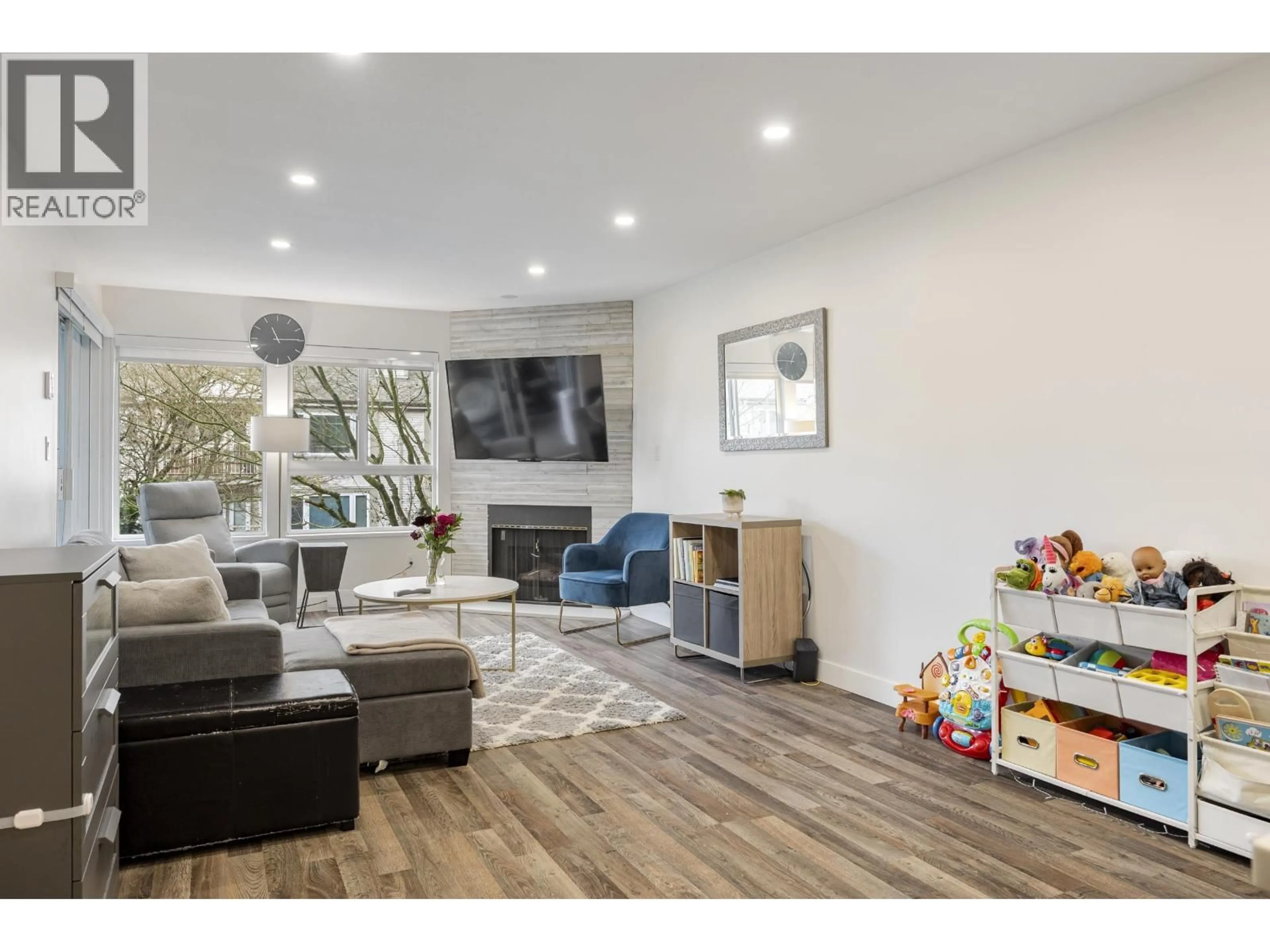 Living room with furniture, wood/laminate floor for 205 - 7465 SANDBORNE AVENUE, Burnaby British Columbia V3N4W7