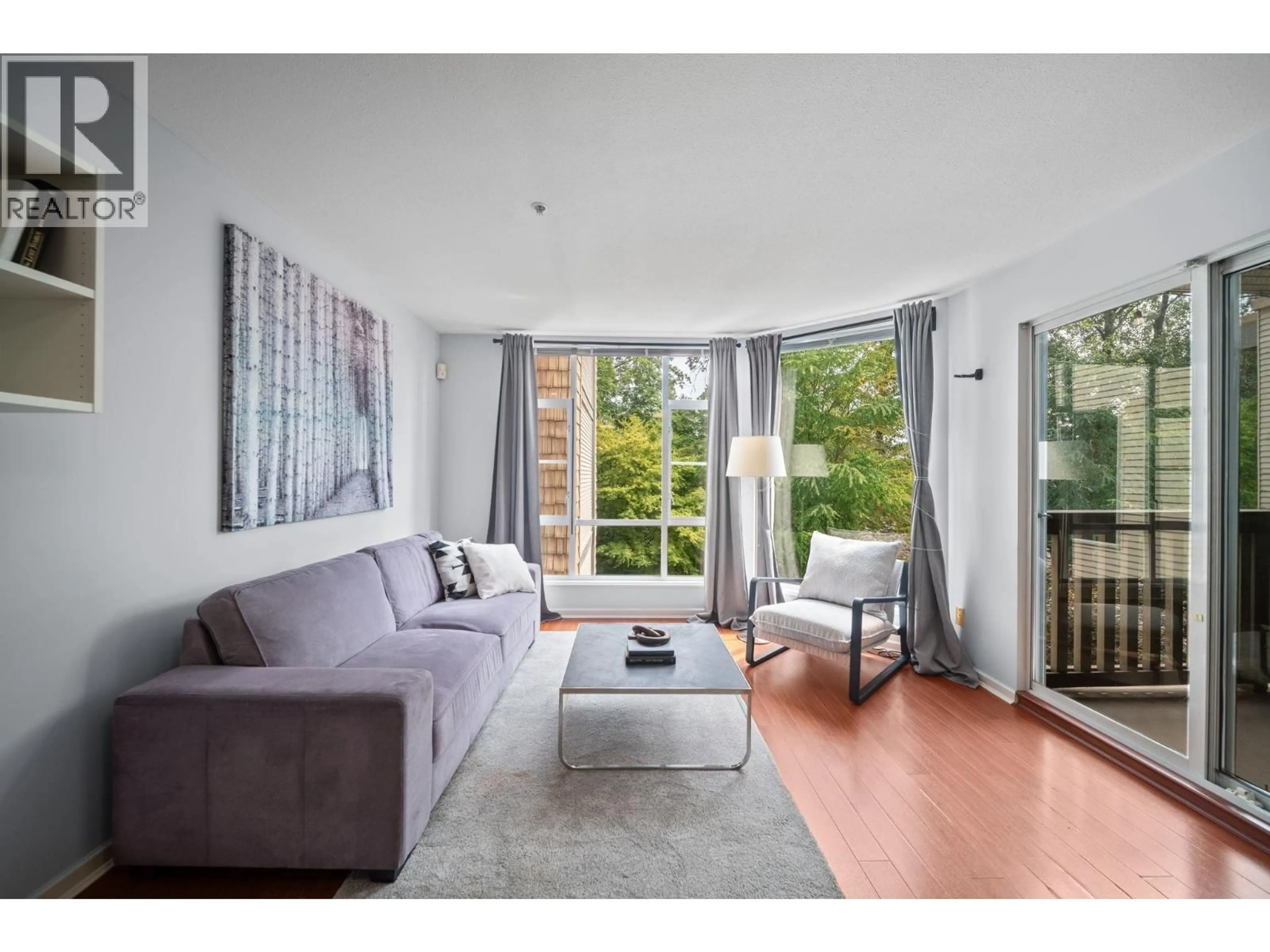 Living room with furniture, wood/laminate floor for 401 - 22233 RIVER ROAD, Maple Ridge British Columbia V2X3N7
