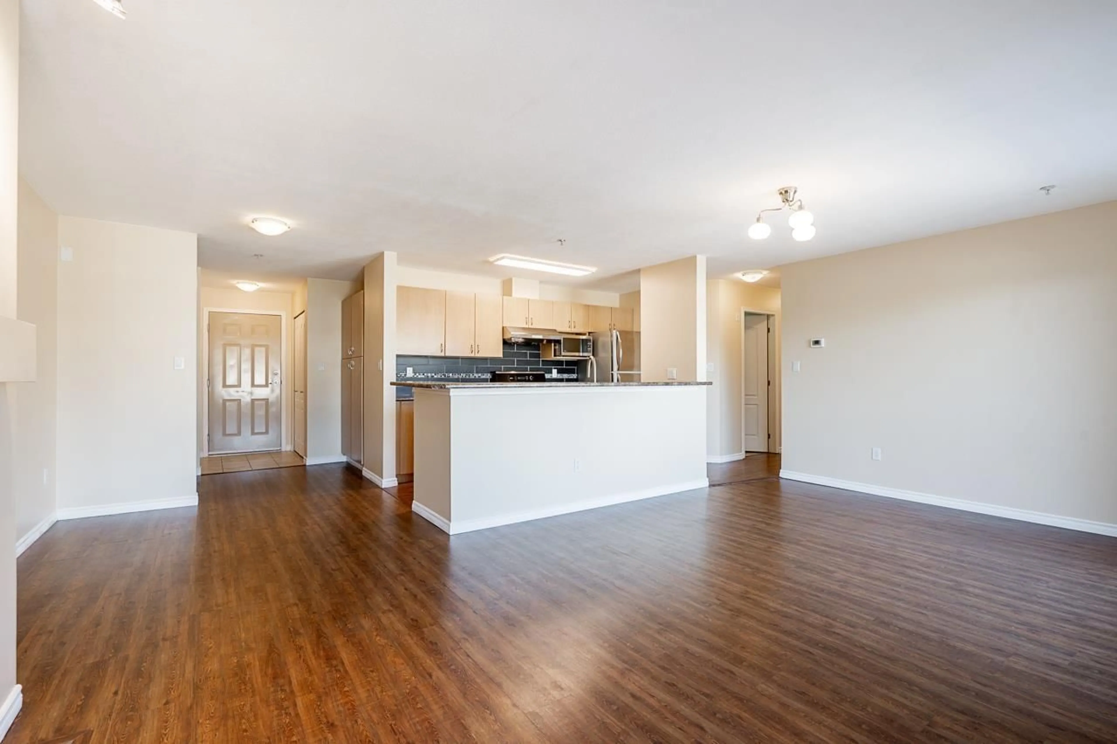 Open concept kitchen, wood/laminate floor for 401 - 15220 GUILDFORD DRIVE, Surrey British Columbia V3R0Y6