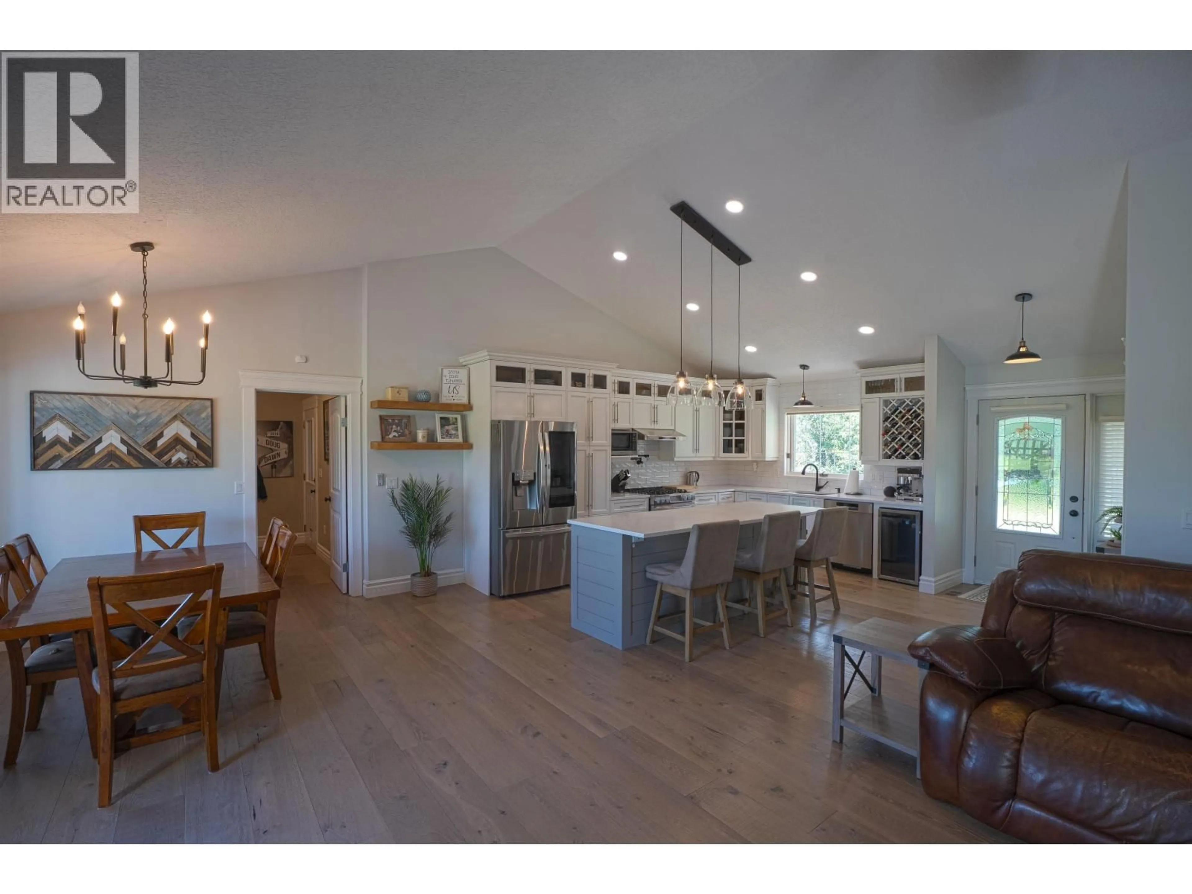Open concept kitchen, wood/laminate floor for 10583 86 STREET, Fort St. John British Columbia V1J8E4