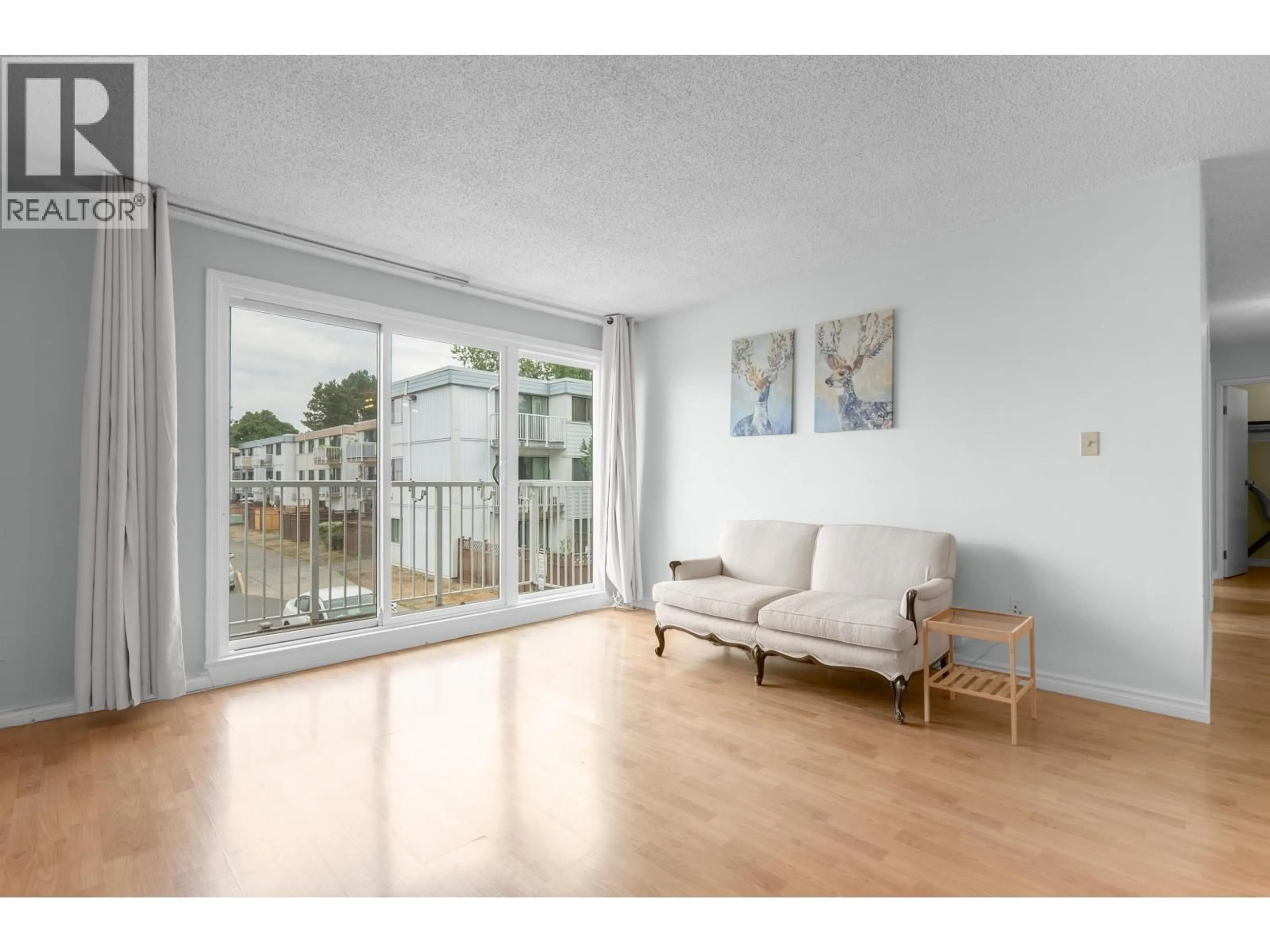Living room with furniture, wood/laminate floor for 205 - 7240 LINDSAY ROAD, Richmond British Columbia V7C3M6