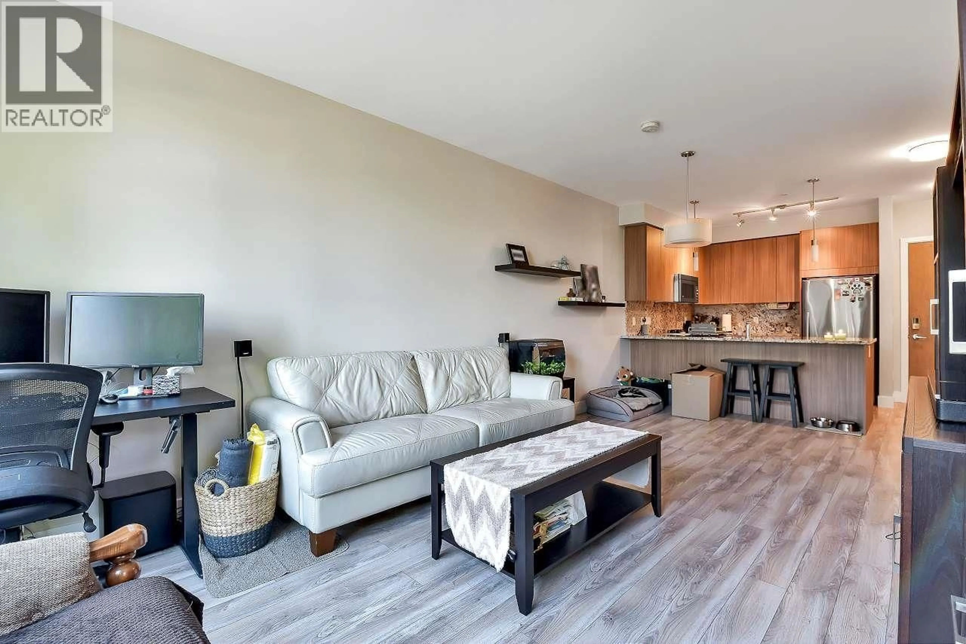 Living room with furniture, wood/laminate floor for 203 - 4307 HASTINGS STREET, Burnaby British Columbia V5C2J7