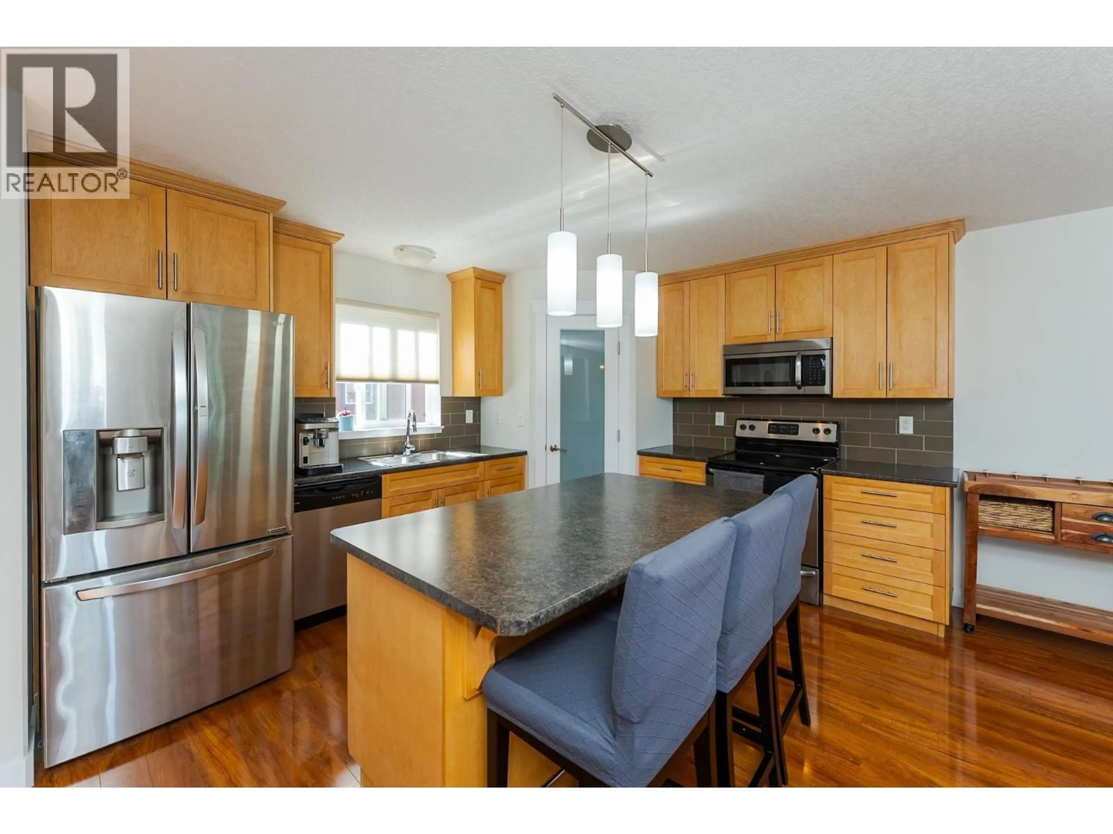 Open concept kitchen, wood/laminate floor for 106 - 1699 7TH AVENUE, Prince George British Columbia V2L0C1