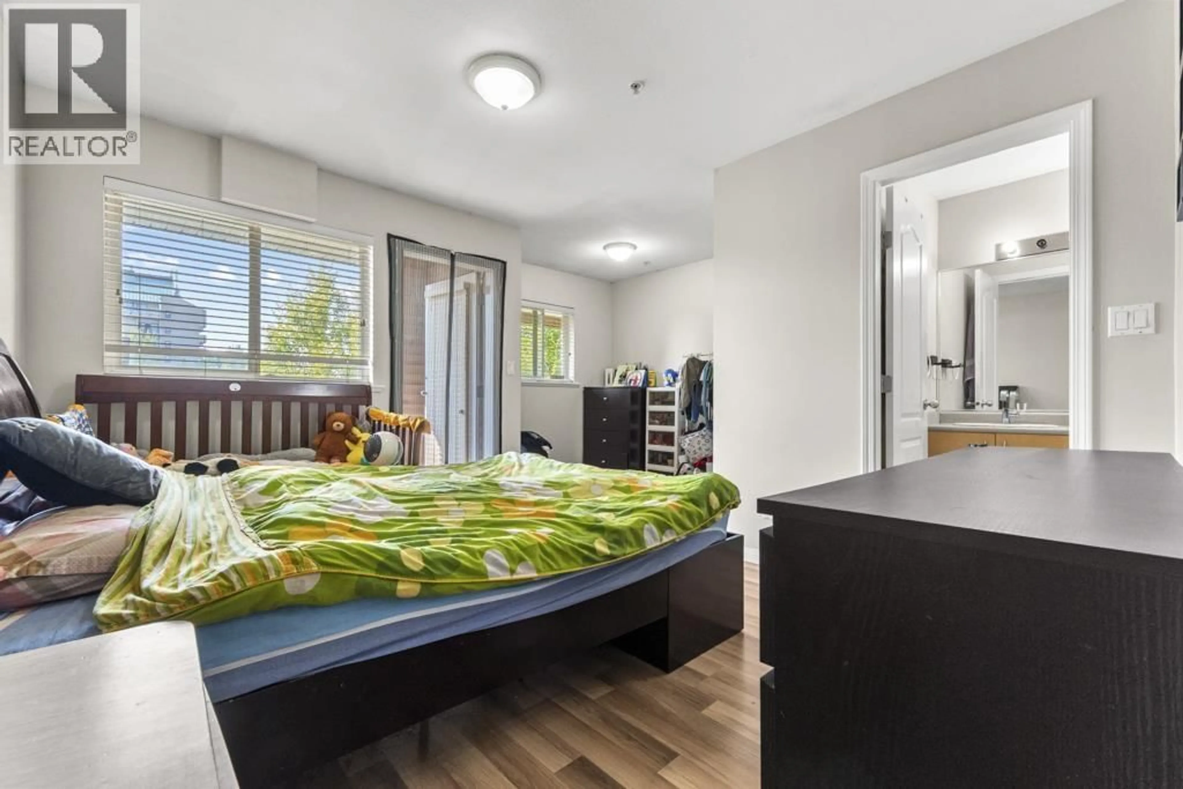 Bedroom with bed, wood/laminate floor for 203 - 5625 SENLAC STREET, Vancouver British Columbia V5R6G8