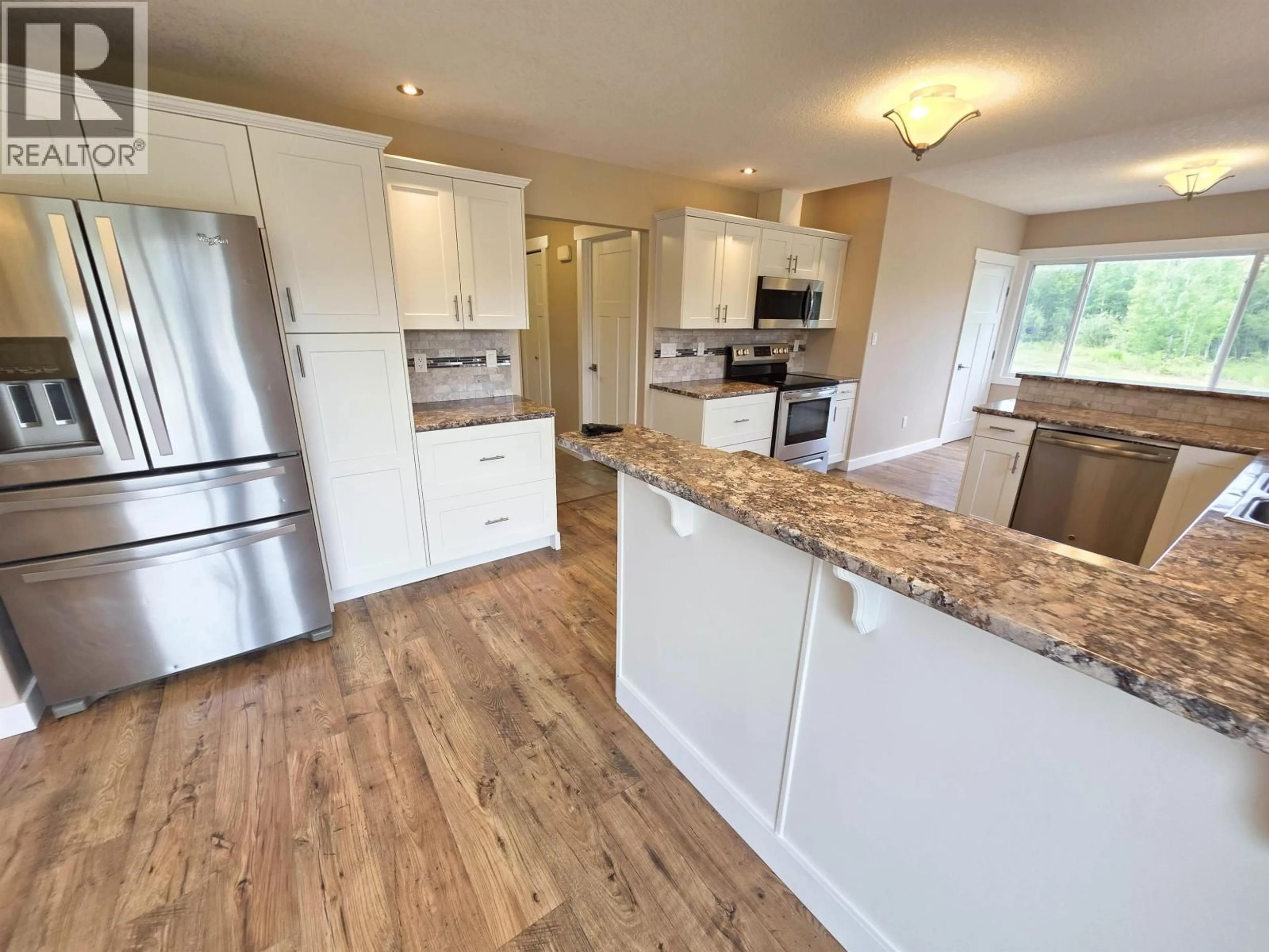 Open concept kitchen, wood/laminate floor for 7446 255 ROAD, Fort St. John British Columbia V0C1C4