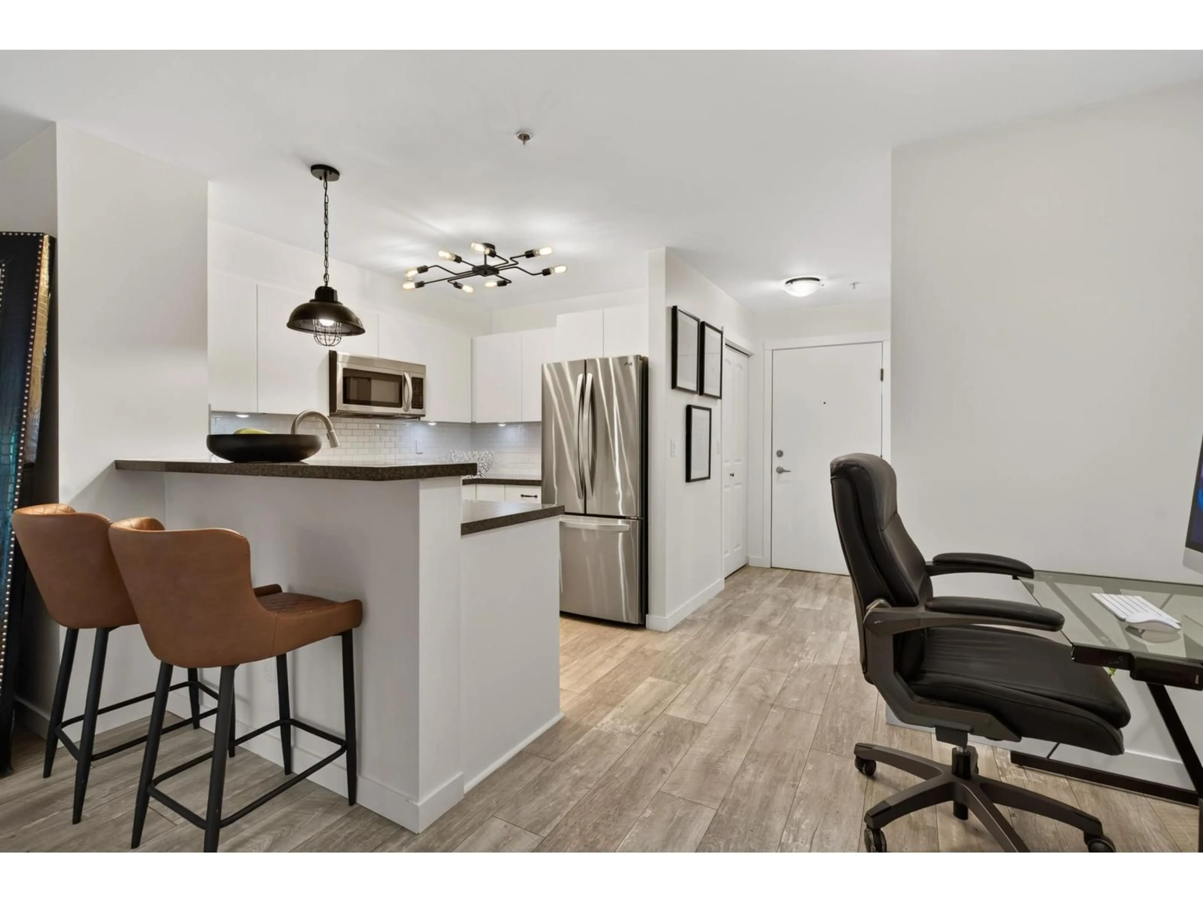 Open concept kitchen, wood/laminate floor for 407 - 8717 160 STREET, Surrey British Columbia V4N5X7