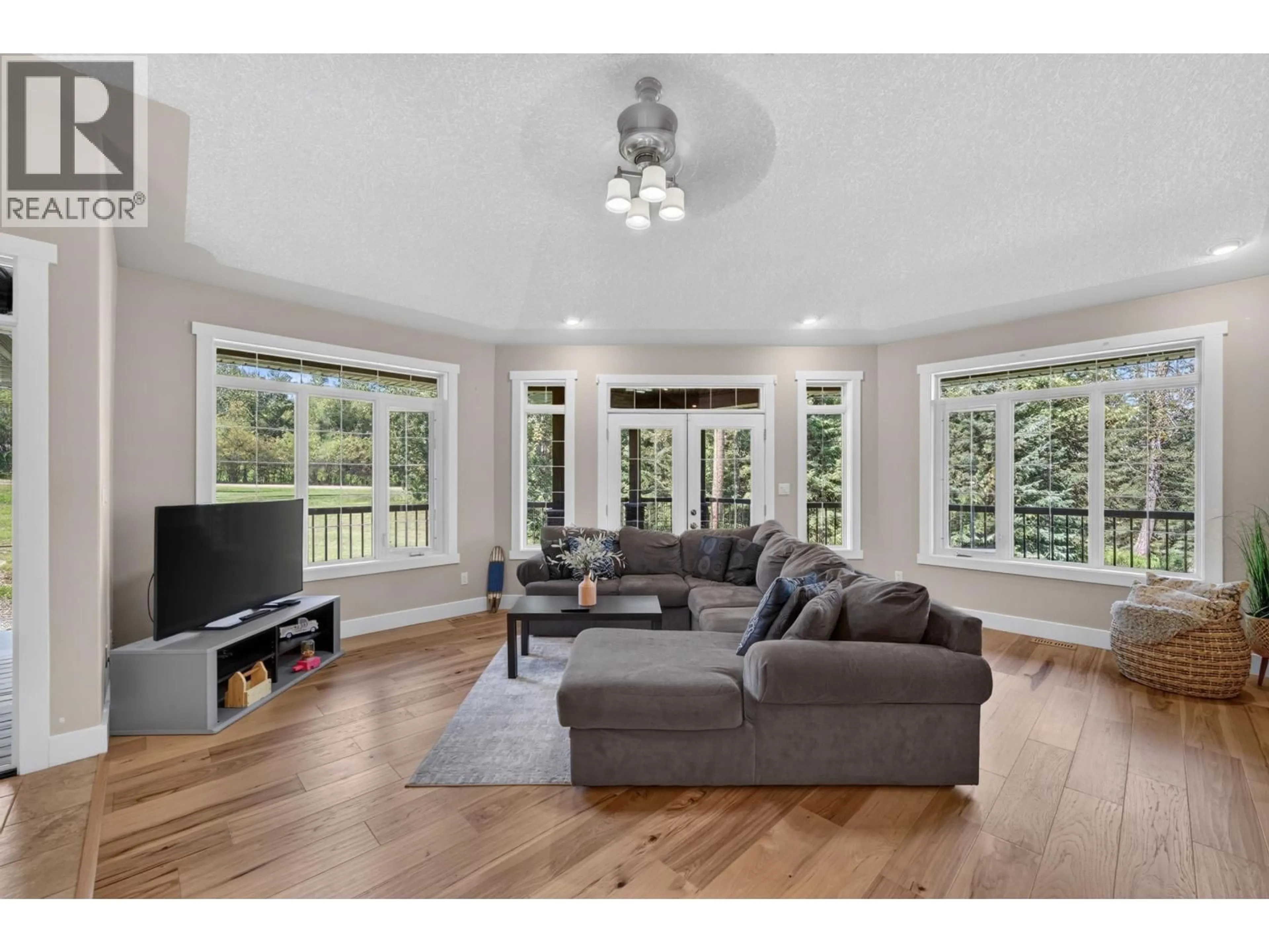 Living room with furniture, wood/laminate floor for 13537 281 ROAD, Charlie Lake British Columbia V1J8J4
